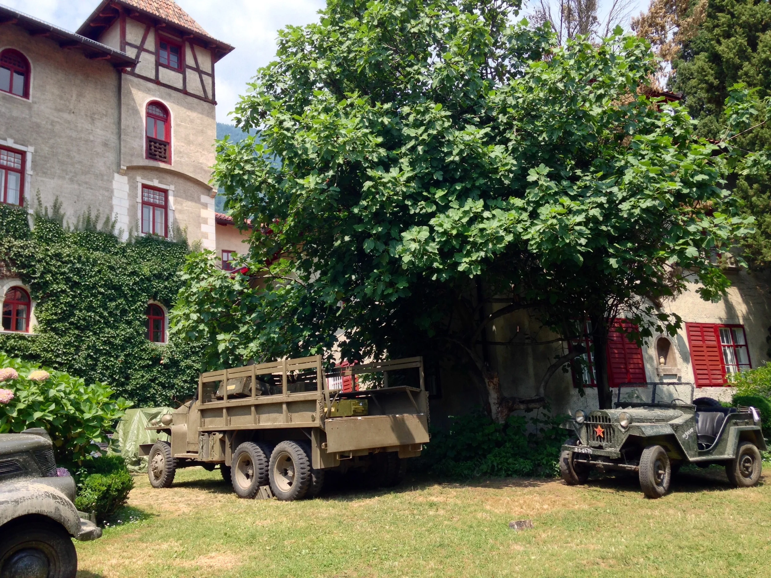 The vehicles in front of the incredible beautiful movie mansion