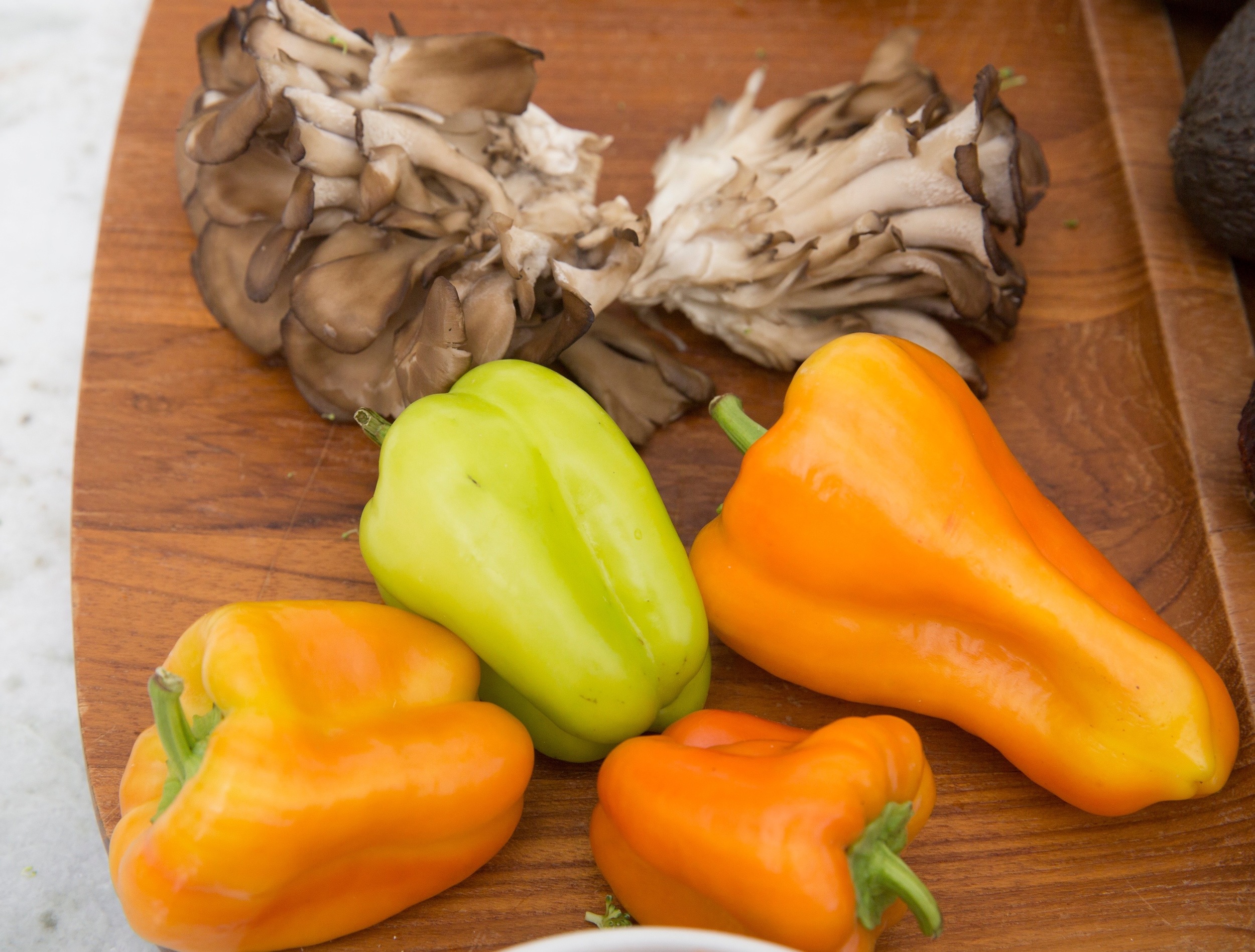 Miatake mushrooms and orange and green bell peppers from Venice.