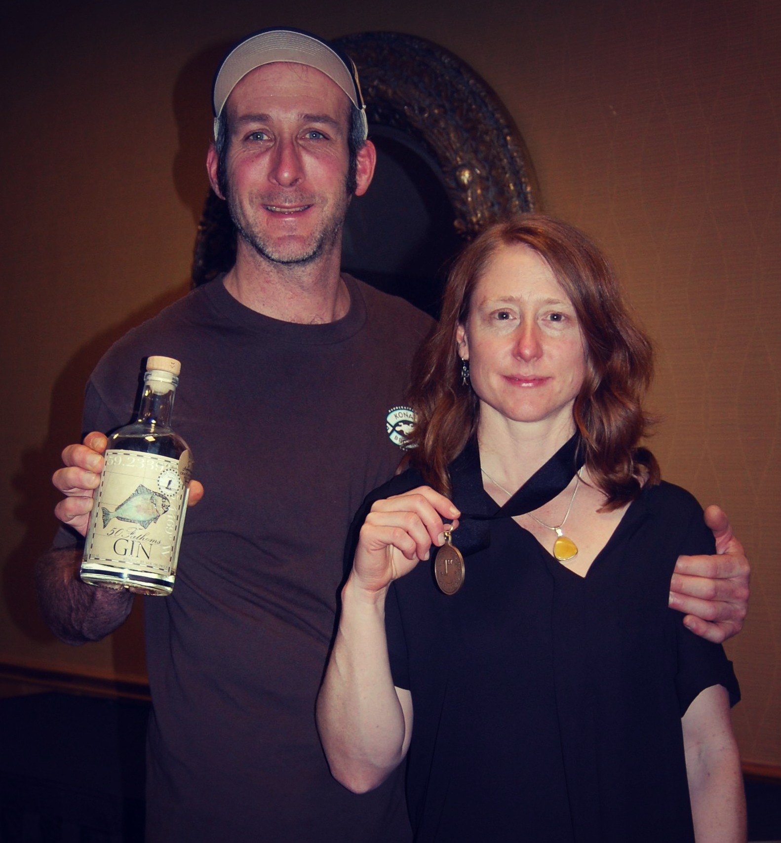 Heather and Sean with their gold medal for 50 Fathoms Gin.