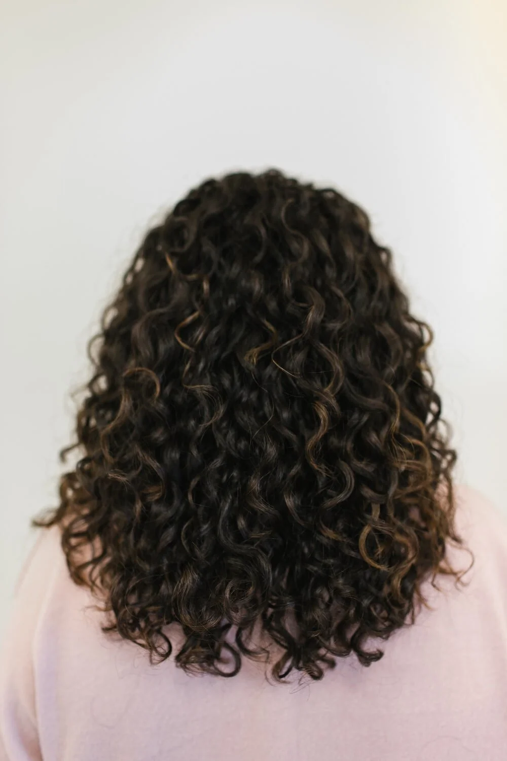 After: the same hair with soft, defined curls following a curl cut and styling at Siren Curl Studio in Tulsa