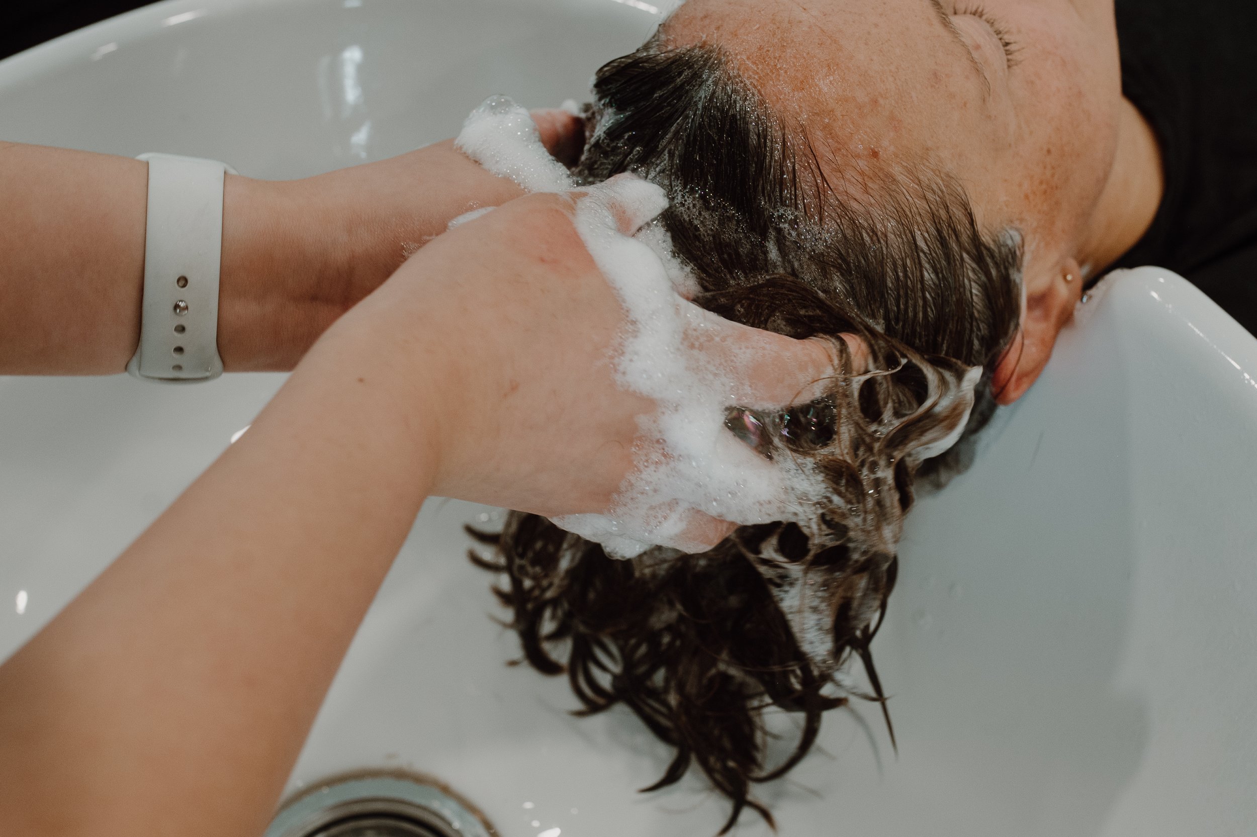 Siren stylist shampooing her client.