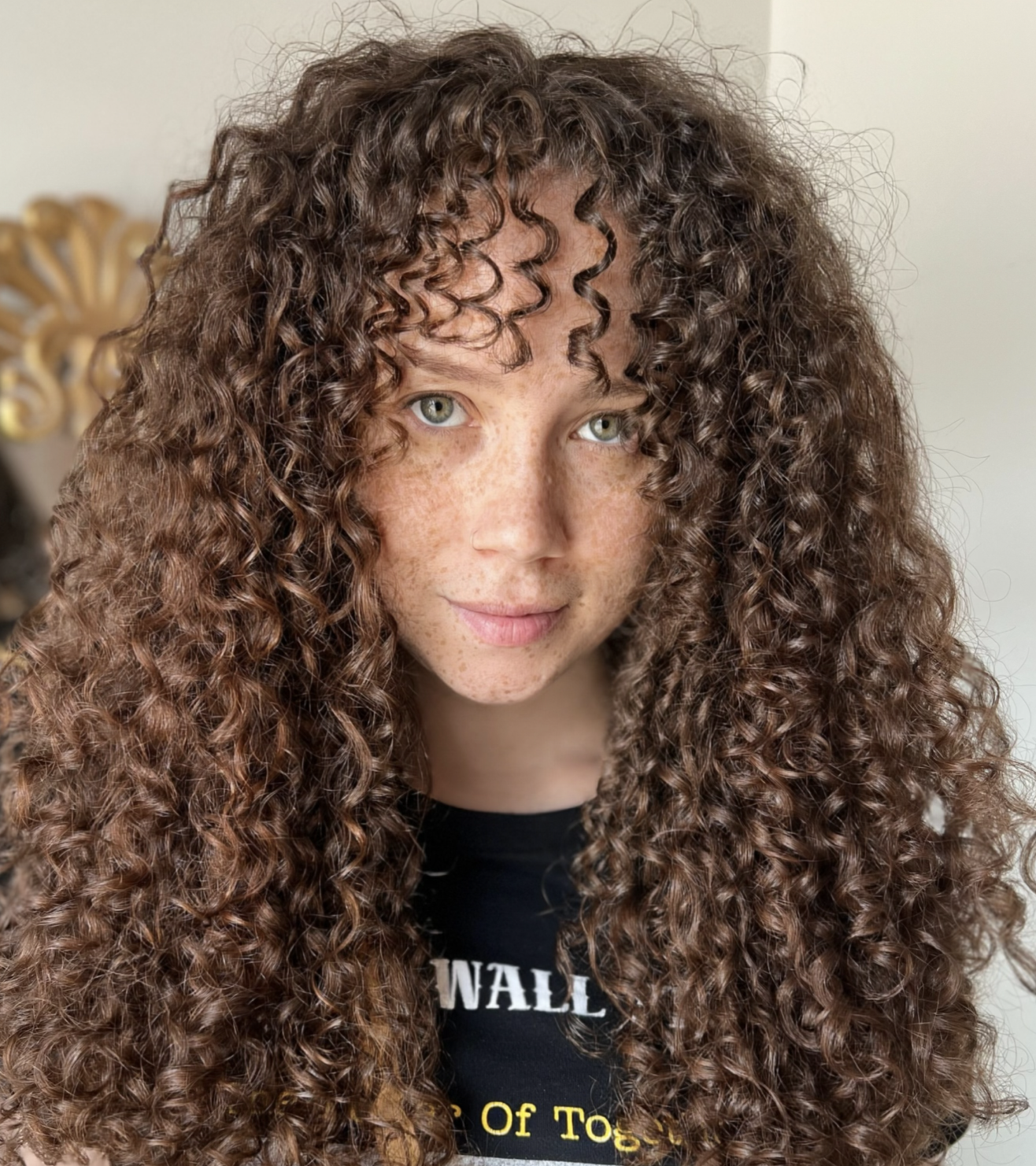 Finished curls after a Siren curl cut and color highlighting movement, balance, and shine.
