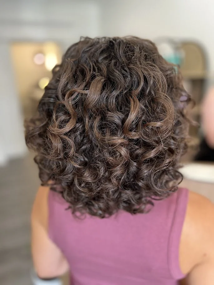 After result of a curl-enhancing haircut at Siren Curl Studio highlighting natural curl pattern and shape.