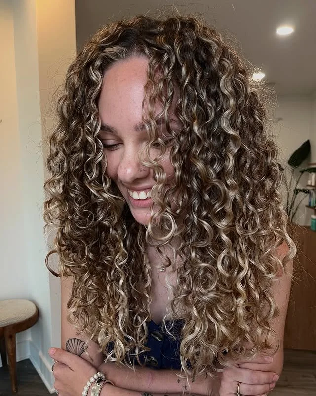 After result of a customized color and cut at Siren featuring dimensional color and shaped curls.