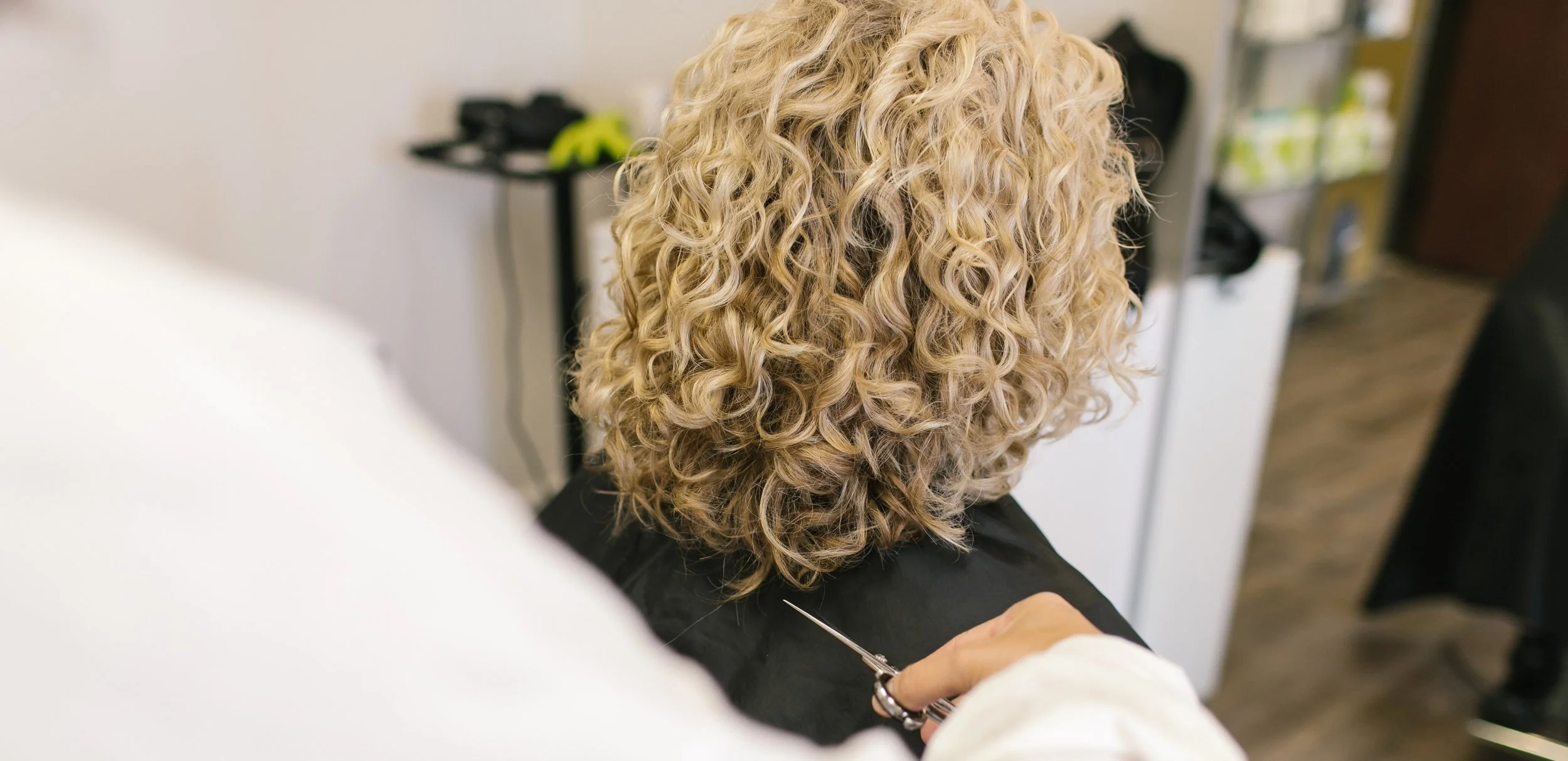 Close-up of healthy, refreshed blonde curls after a professional curl service at Siren Curl Studio.