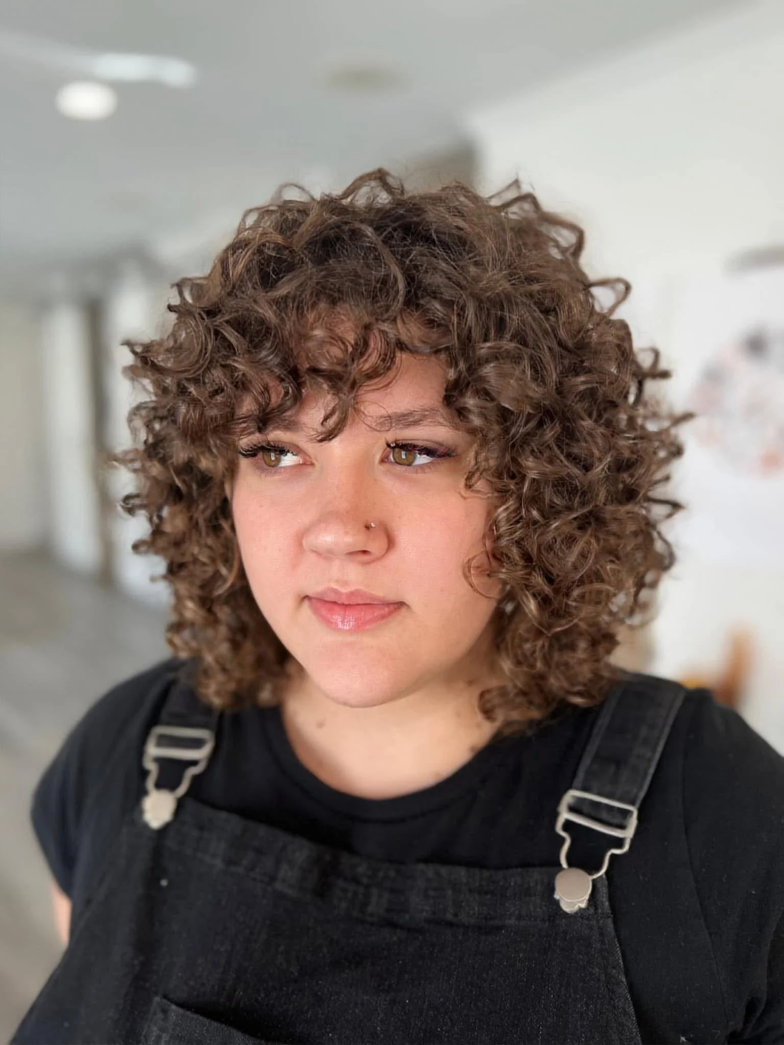 Curly haircut after result at Siren showing balanced shape with enhanced curl definition.