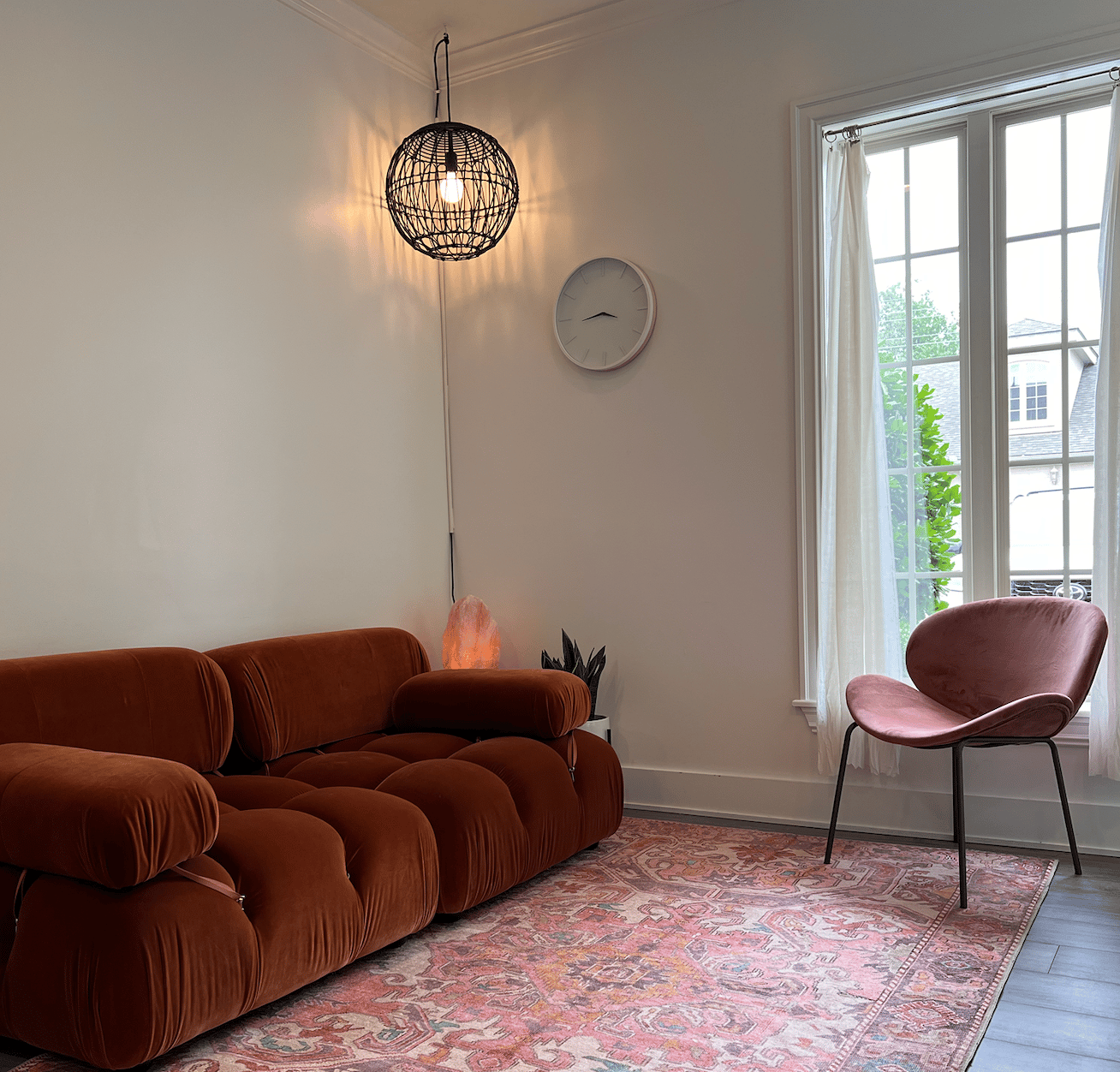 Interior photo of Siren Curl Studio highlighting the comfortable sofa seating where clients wait and enjoy complimentary beverages