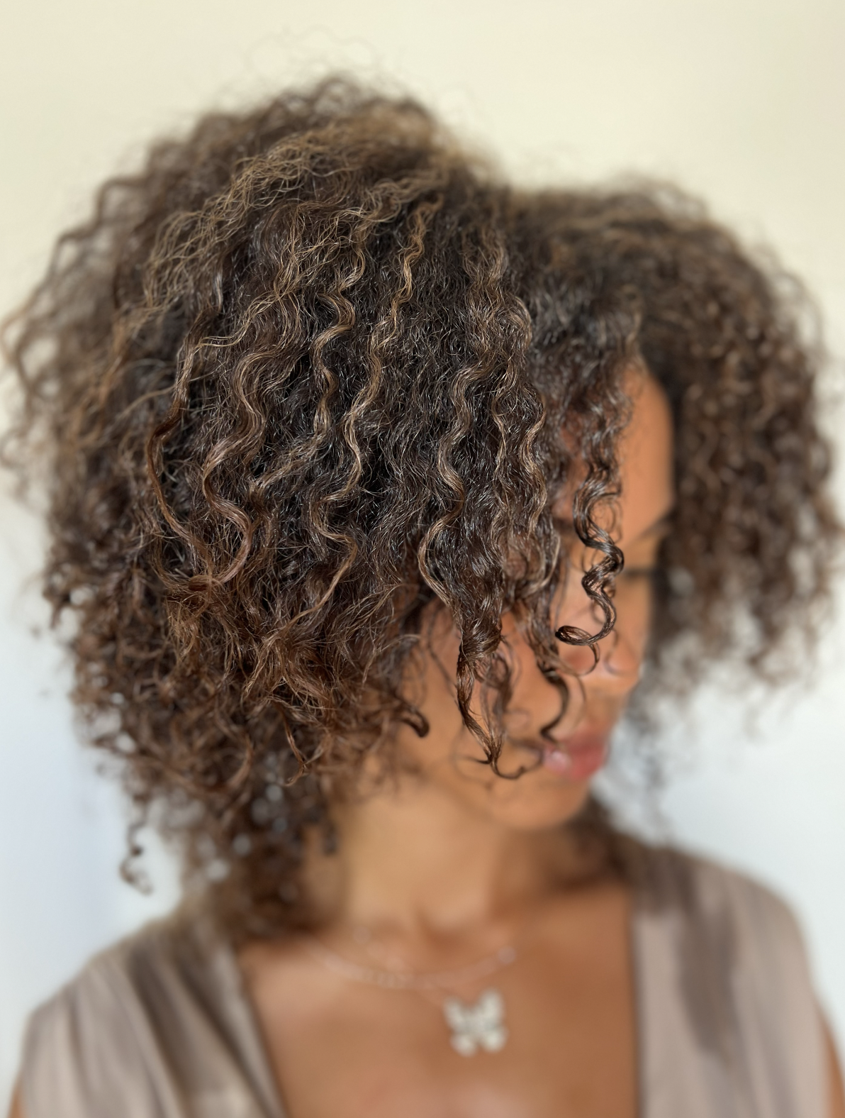 After result of shaped curls at Siren Curl Studio showcasing beautifully blended color and defined curl structure.