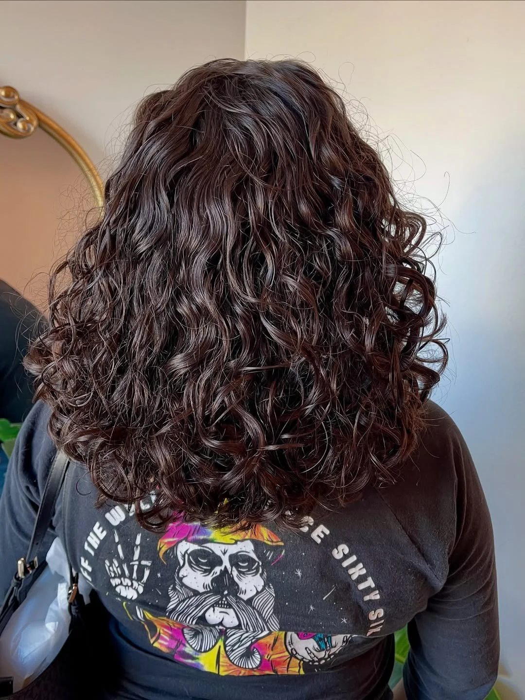 After photo of a curly haircut at Siren revealing refreshed curls with improved shape and structure.