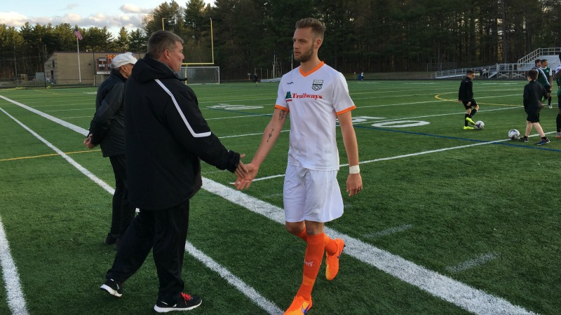 Creswick walks off the pitch at Lowell United FC with a handshake from Goalkeeping Coach Chuck Wilder.
