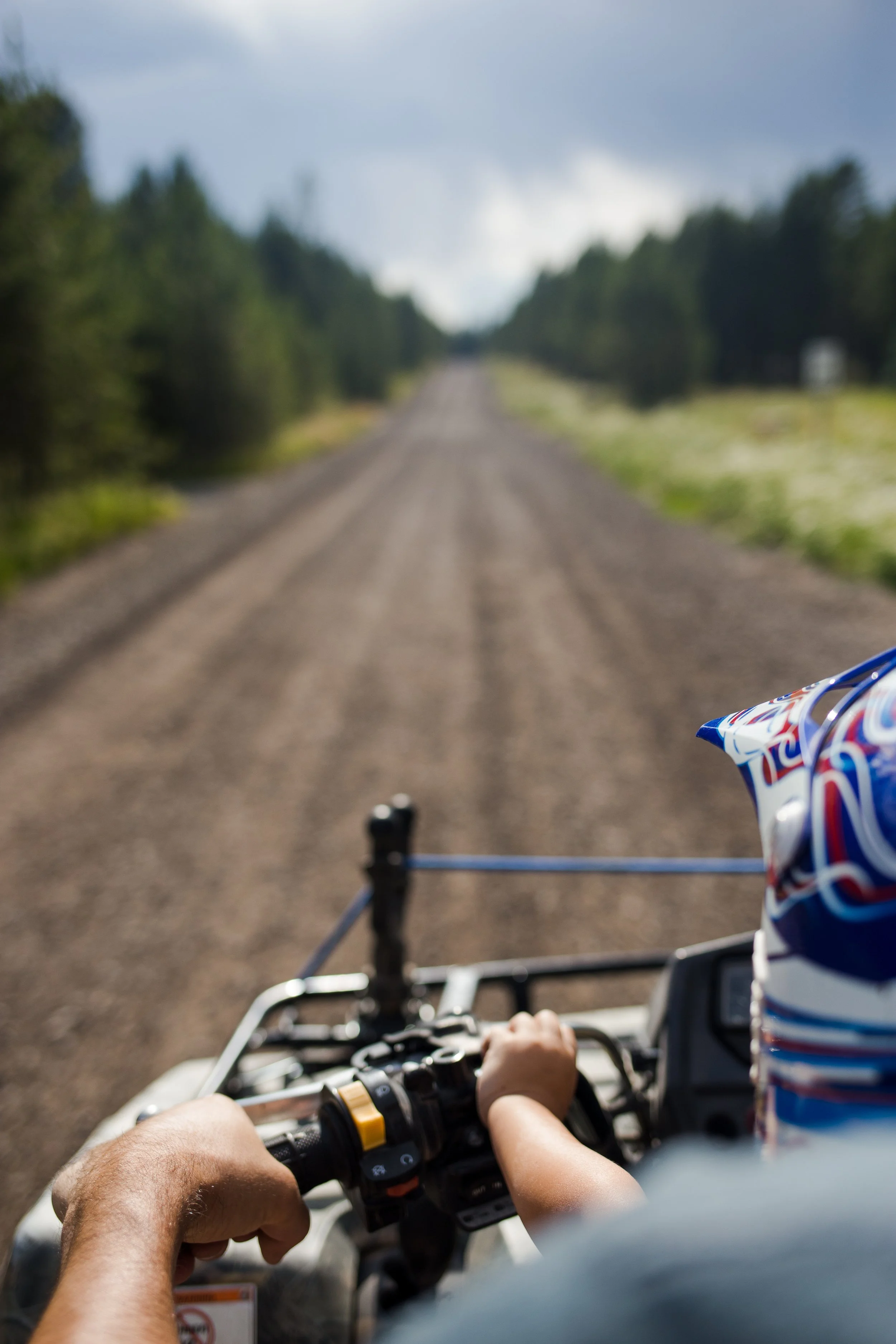 father and son riding 4 wheeler on long road.jpg