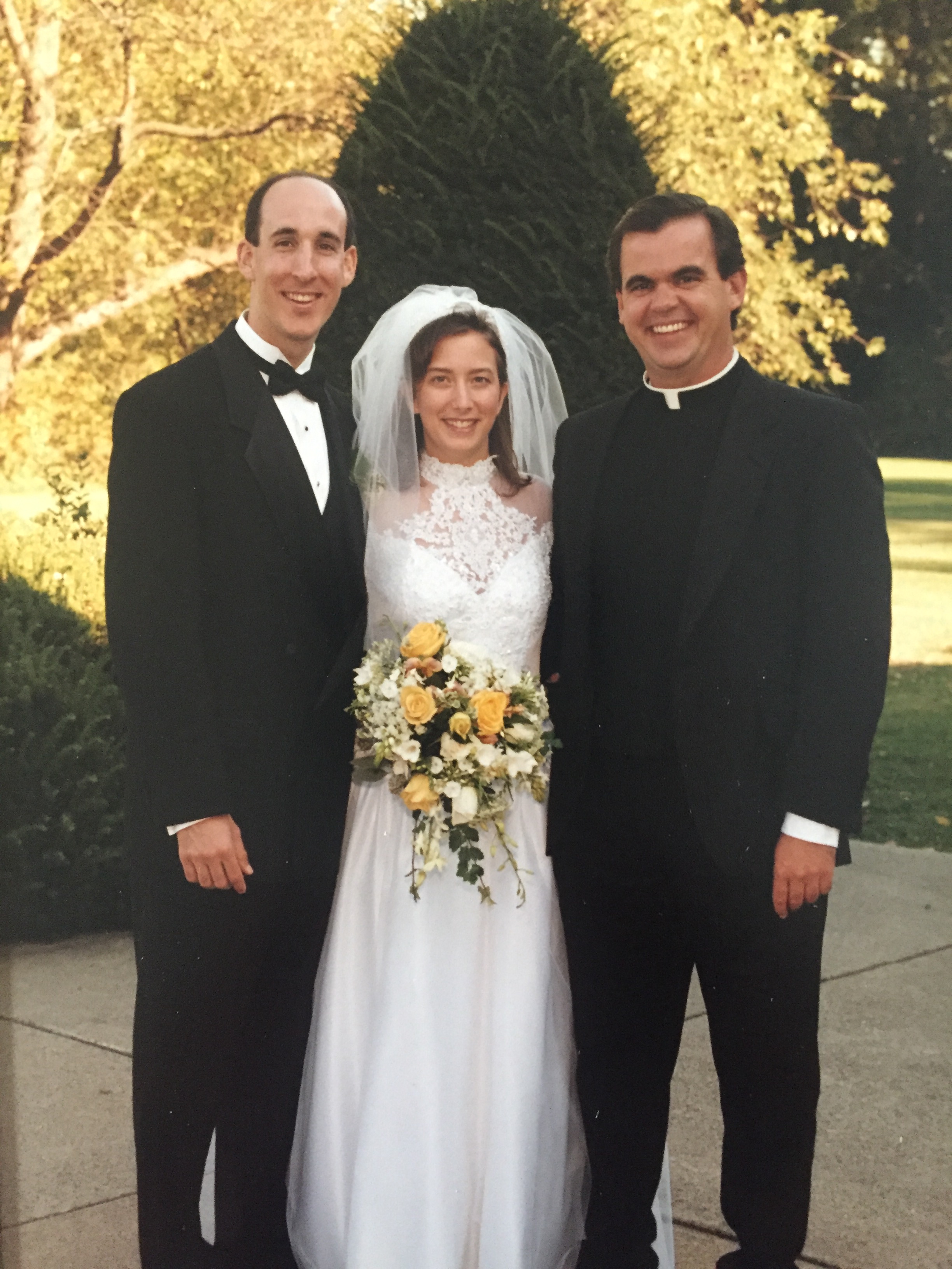 Katy and Tom with Father John Denny, O.S.A.