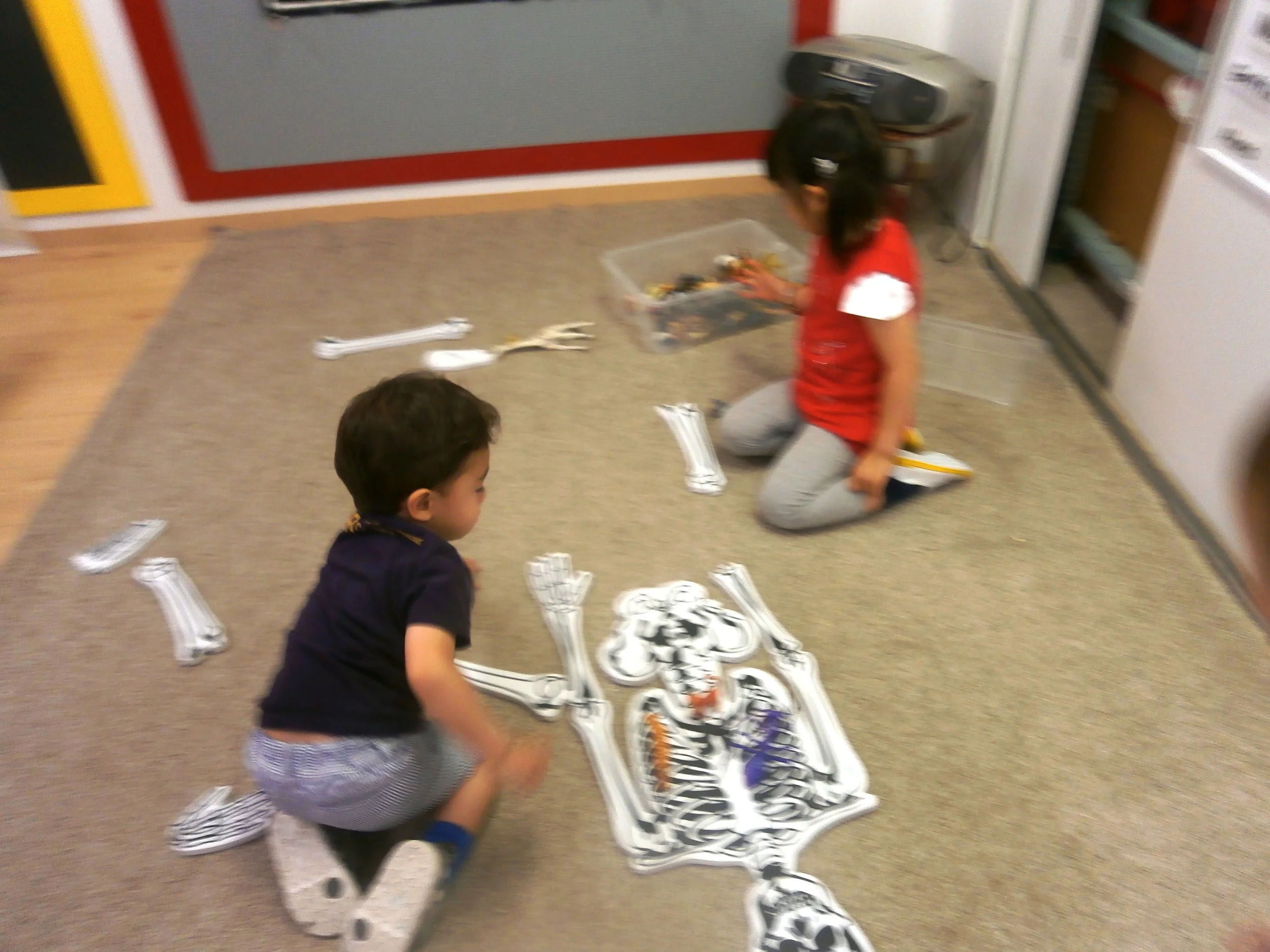 Here are some of our friends trying to finish our big skeleton puzzle.