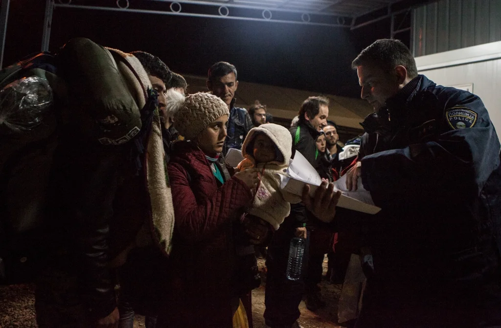Border police check papers at the Macedonian/Serbian border.