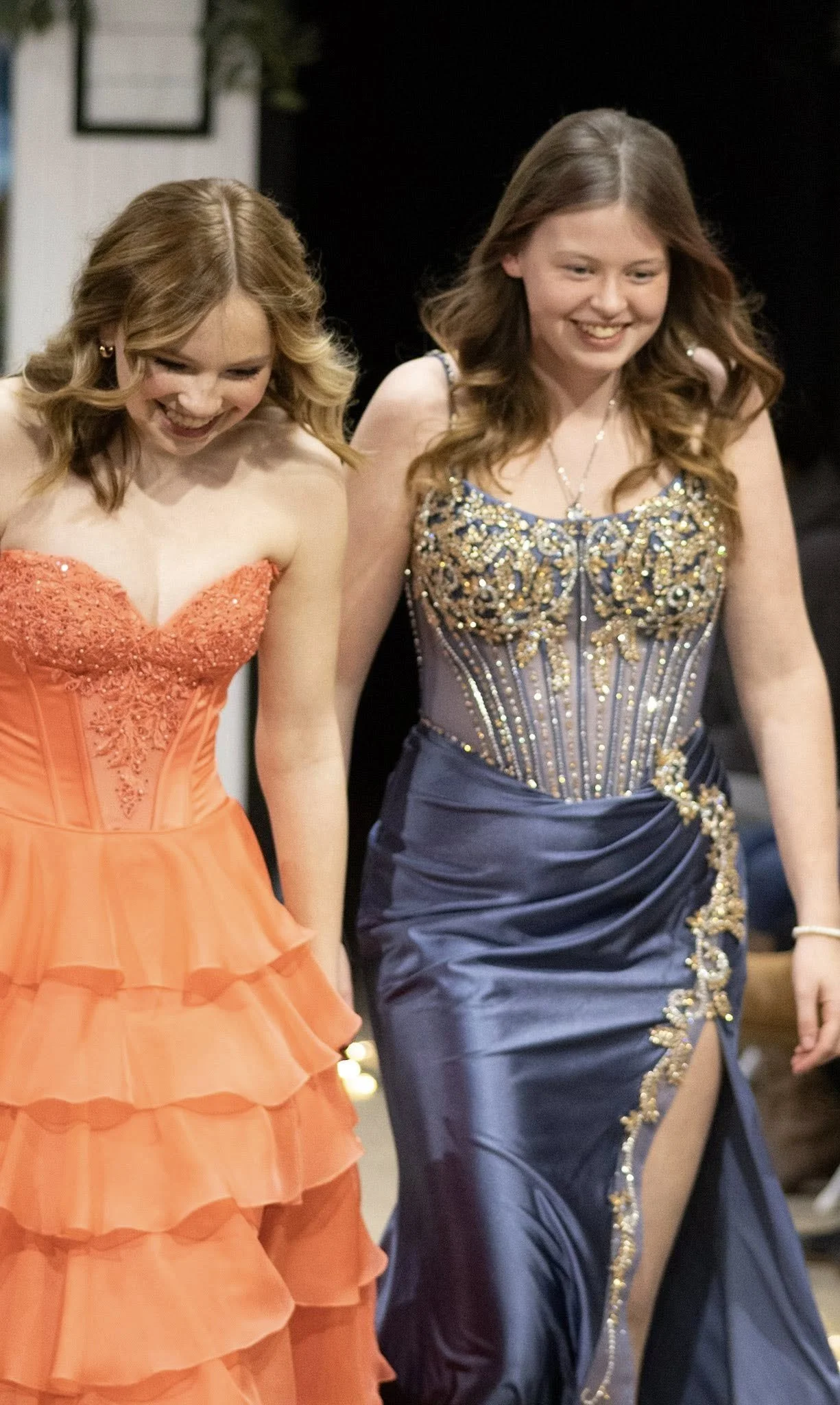 girls wearing prom dresses