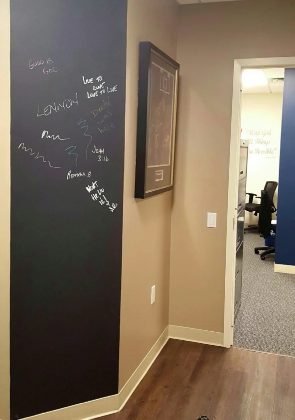 Black Chalk Board paint, from Benjamin Moore has been applied to the wall, so it can be used as an information work center and a play wall for when the kids visit.