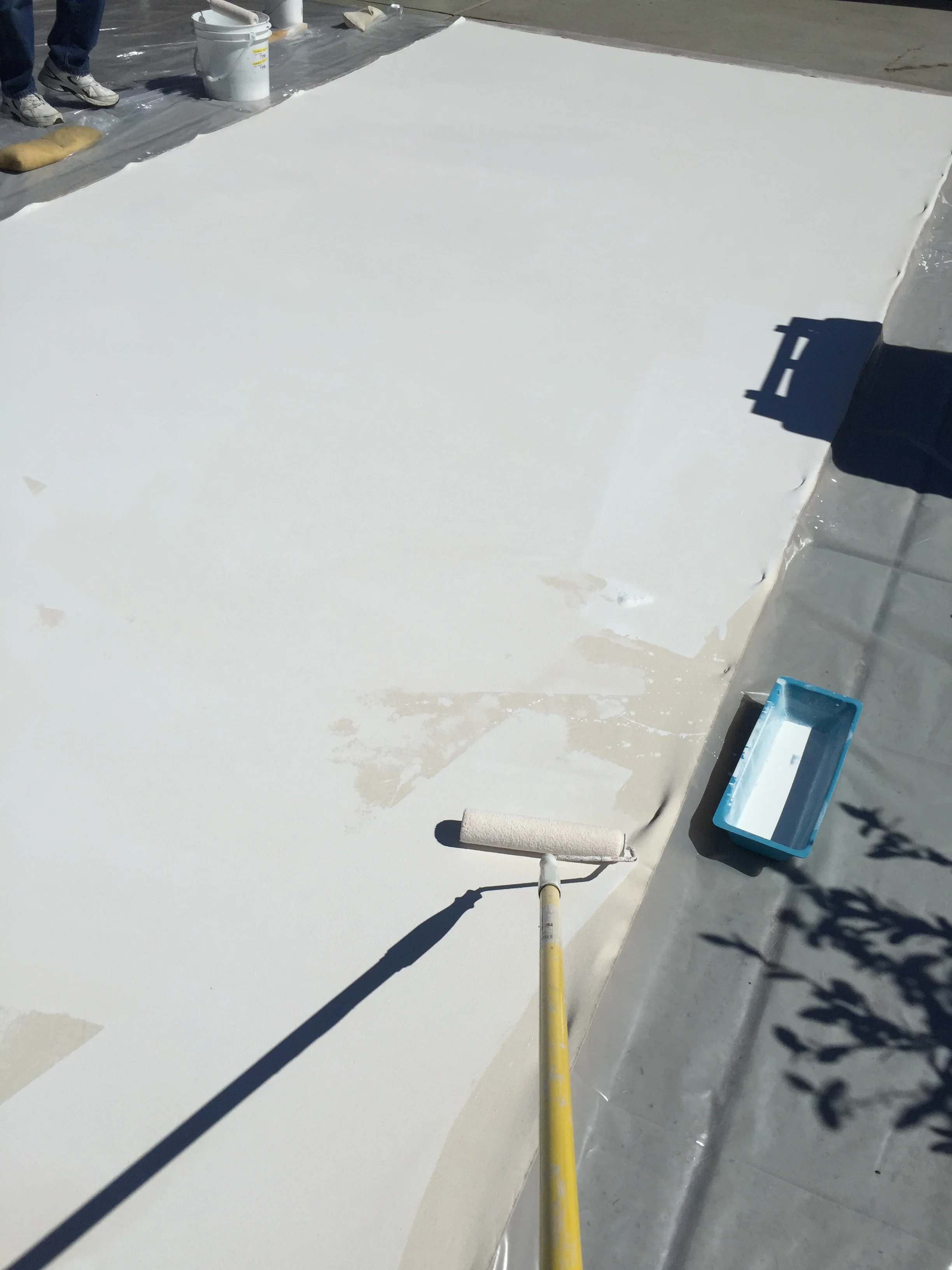 Priming the tan canvas.