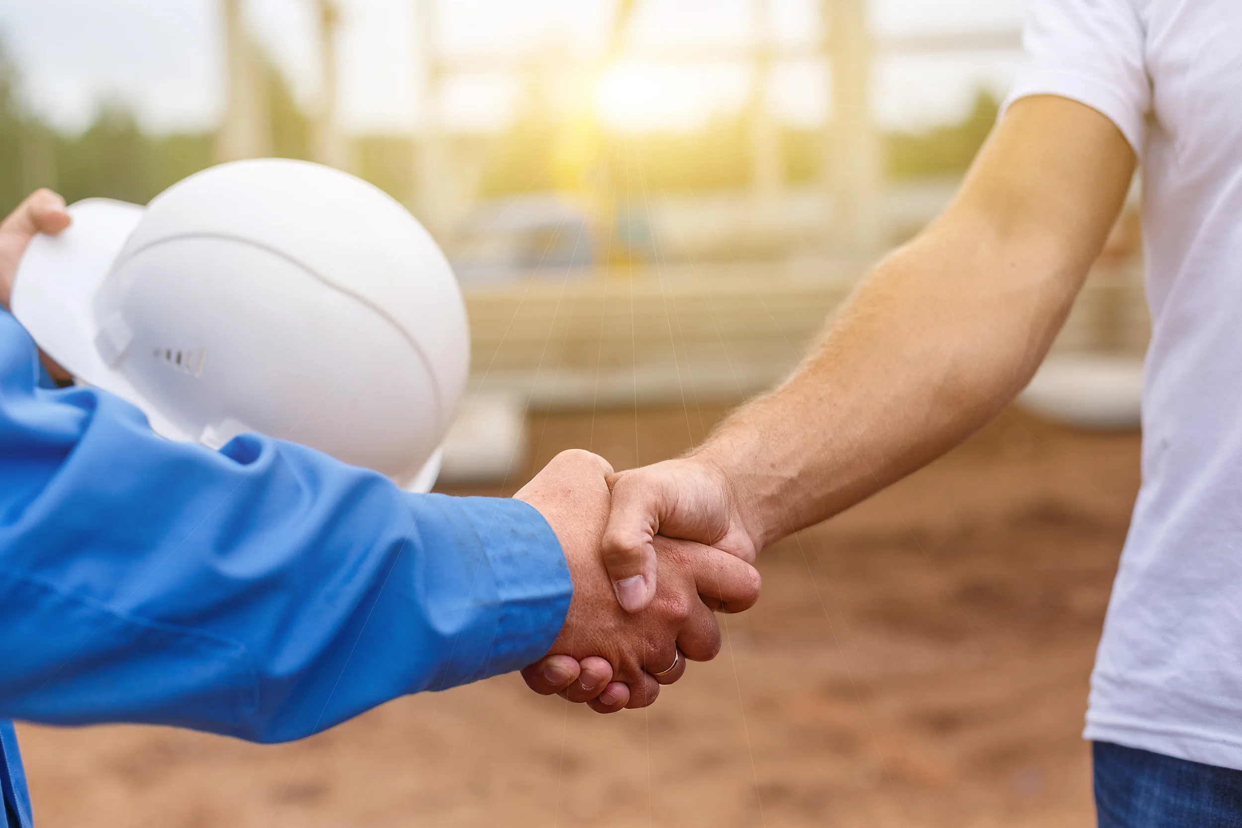 bigstock-builders-shaking-hands-118252484.jpg
