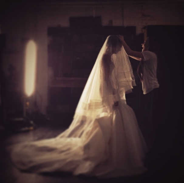 Carol Hannah makes adjustments to the La Reine skirt and 2 tiered horsehair veil
