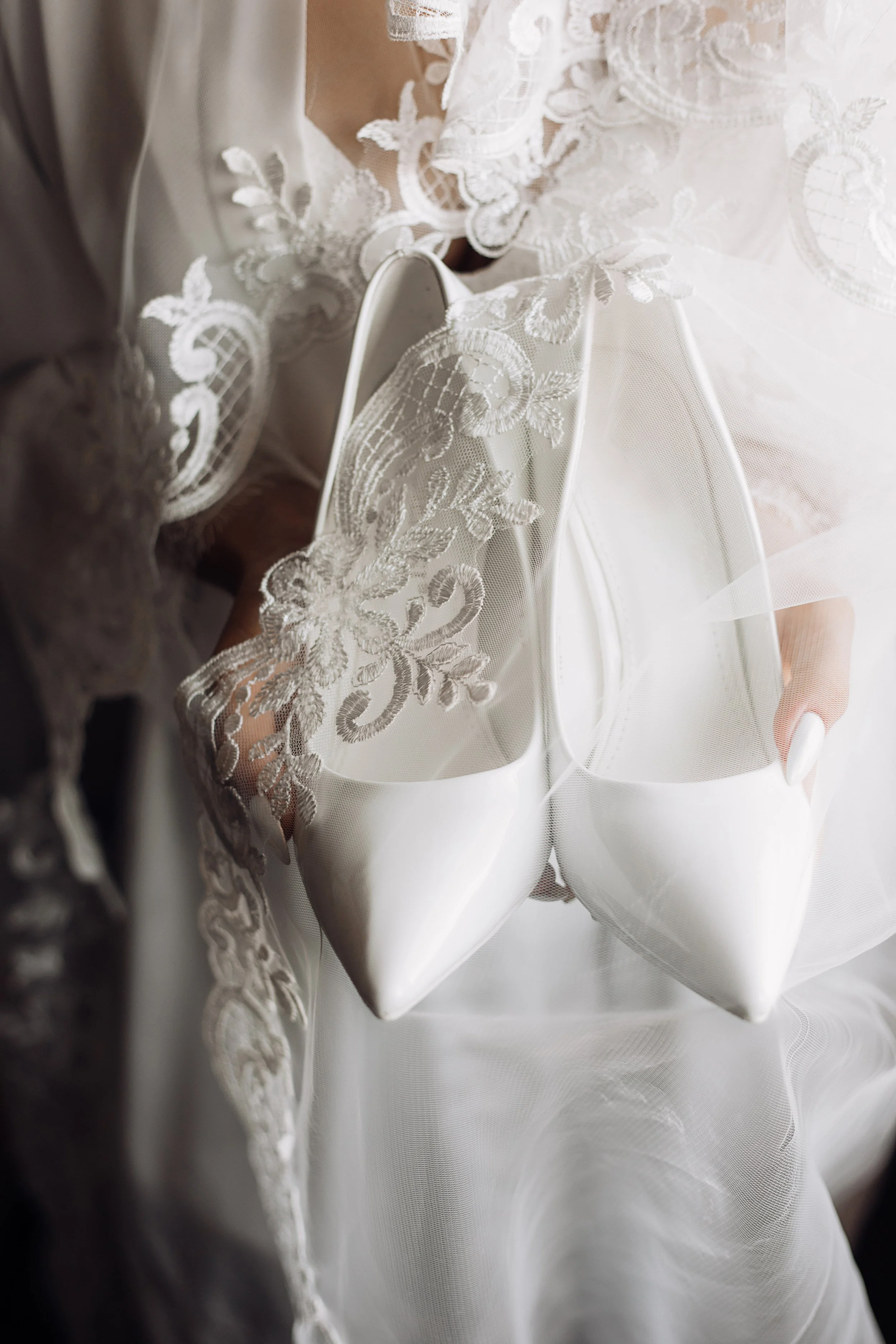 white-wedding-ceremonial-shoes-hands-bride-dressed-silk-nightwear-with-lace.jpg