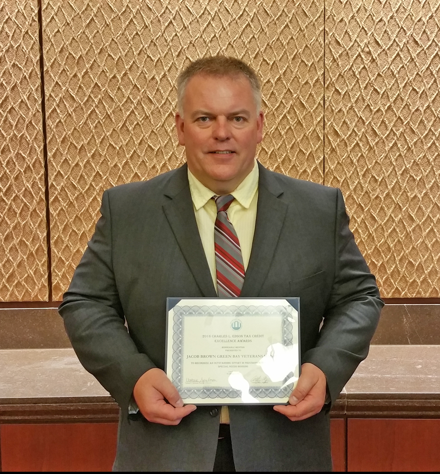 Michael Routheau, on-site Property Manager at Major General Jacob Brown Green Bay Veterans Manor, was present at the Edson Awards ceremony in Washington, DC June 2016 to receive the Honorable Mention certificate.