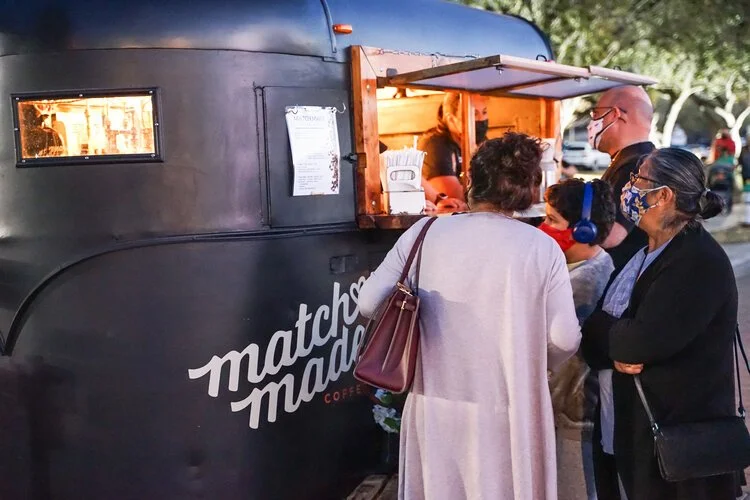 Attendees ordering drinks from the Match Made coffee truck during a City of Edinburg Food Trucks N' Tunes event.