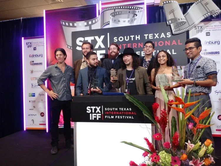 Filmmakers posing with awards at the STX South Texas International Film Festival event in Edinburg.