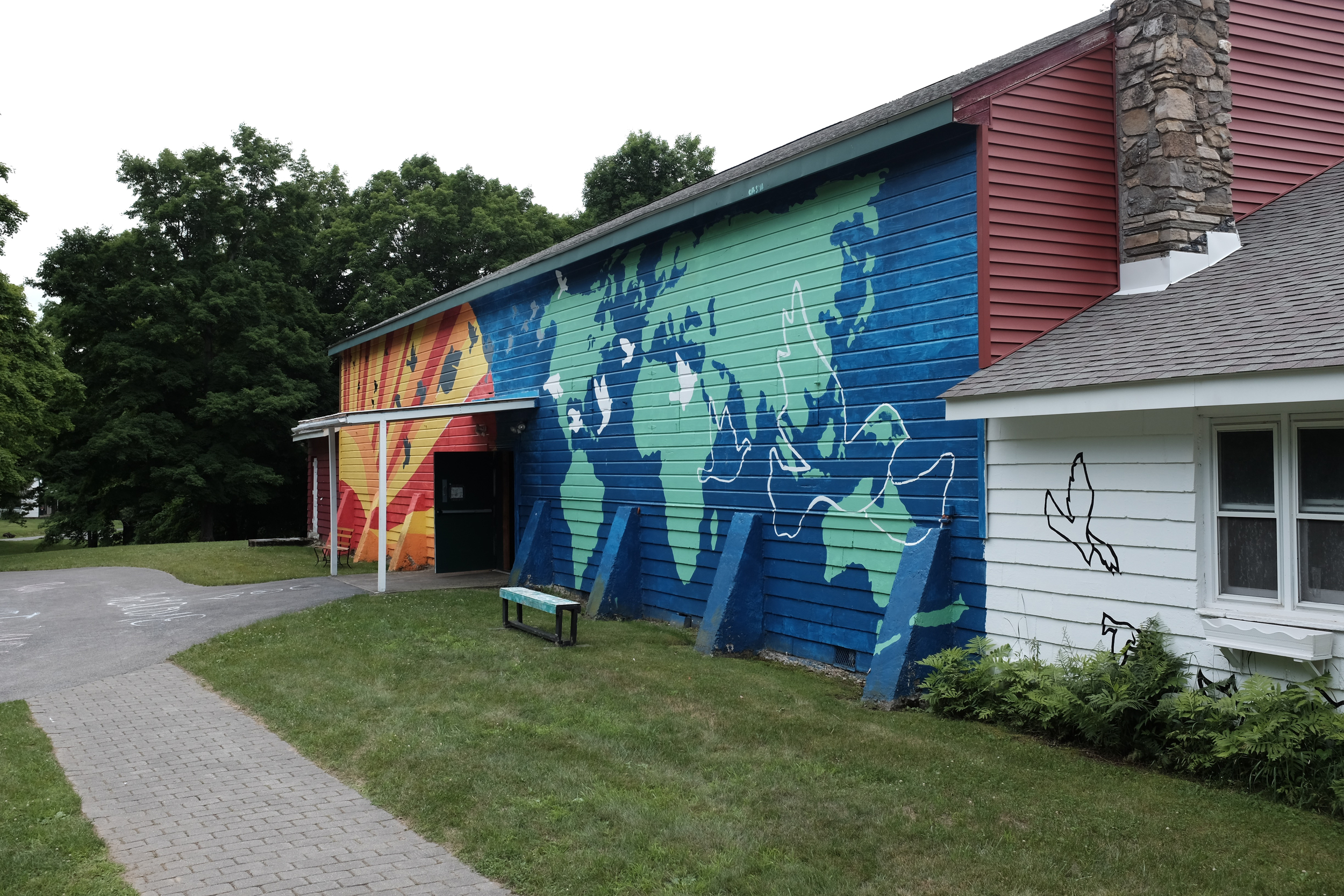  The campus covers about 100 acres in historic Rhinebeck, NY. Pictured here is Main Building, which houses an indoor gym, the dining hall, bathrooms, and a campers' lounge. The mural on the side was painted by campers. 
