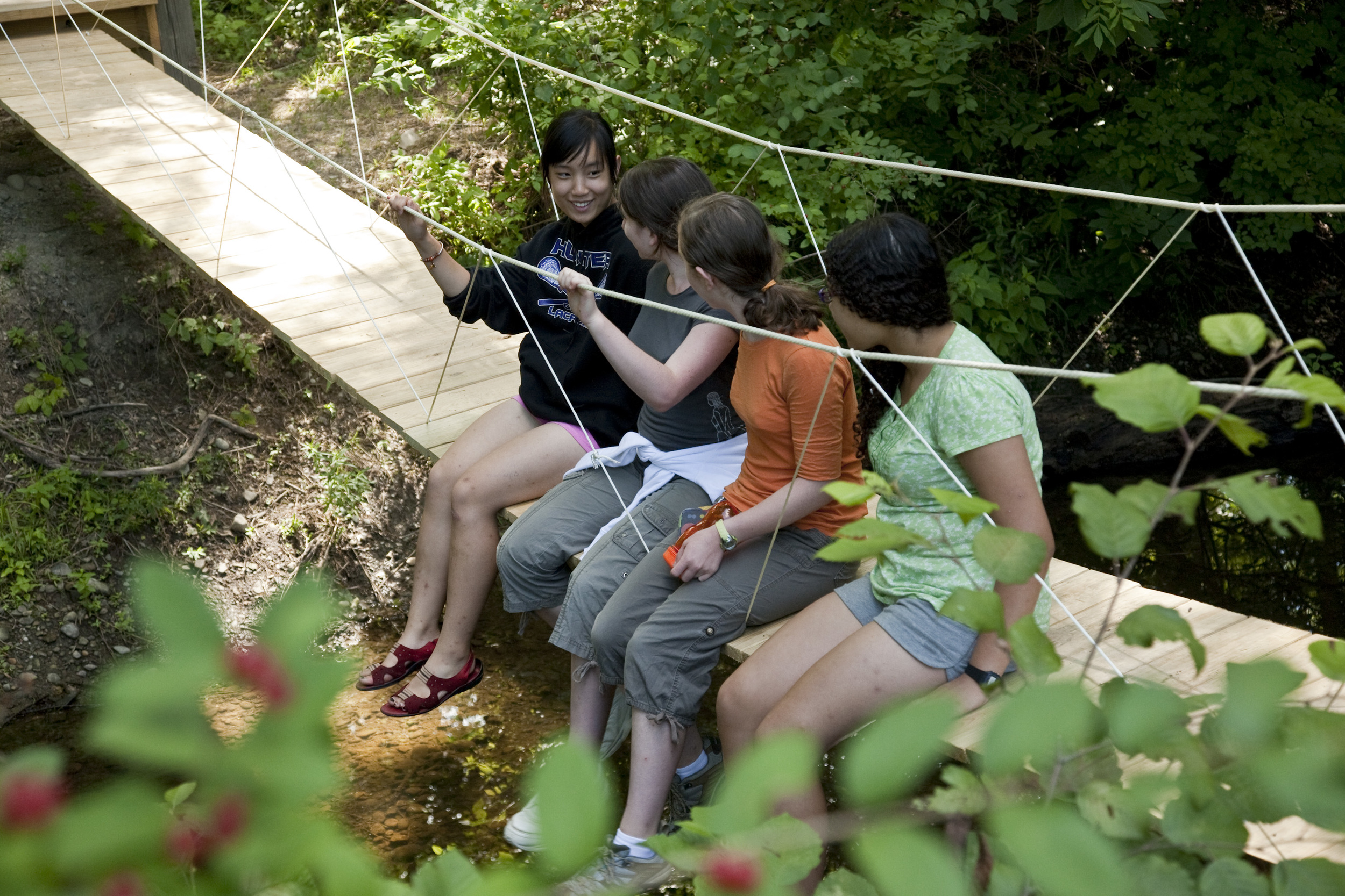  A camper built a suspension bridge that spans a small creek behind the pond. 