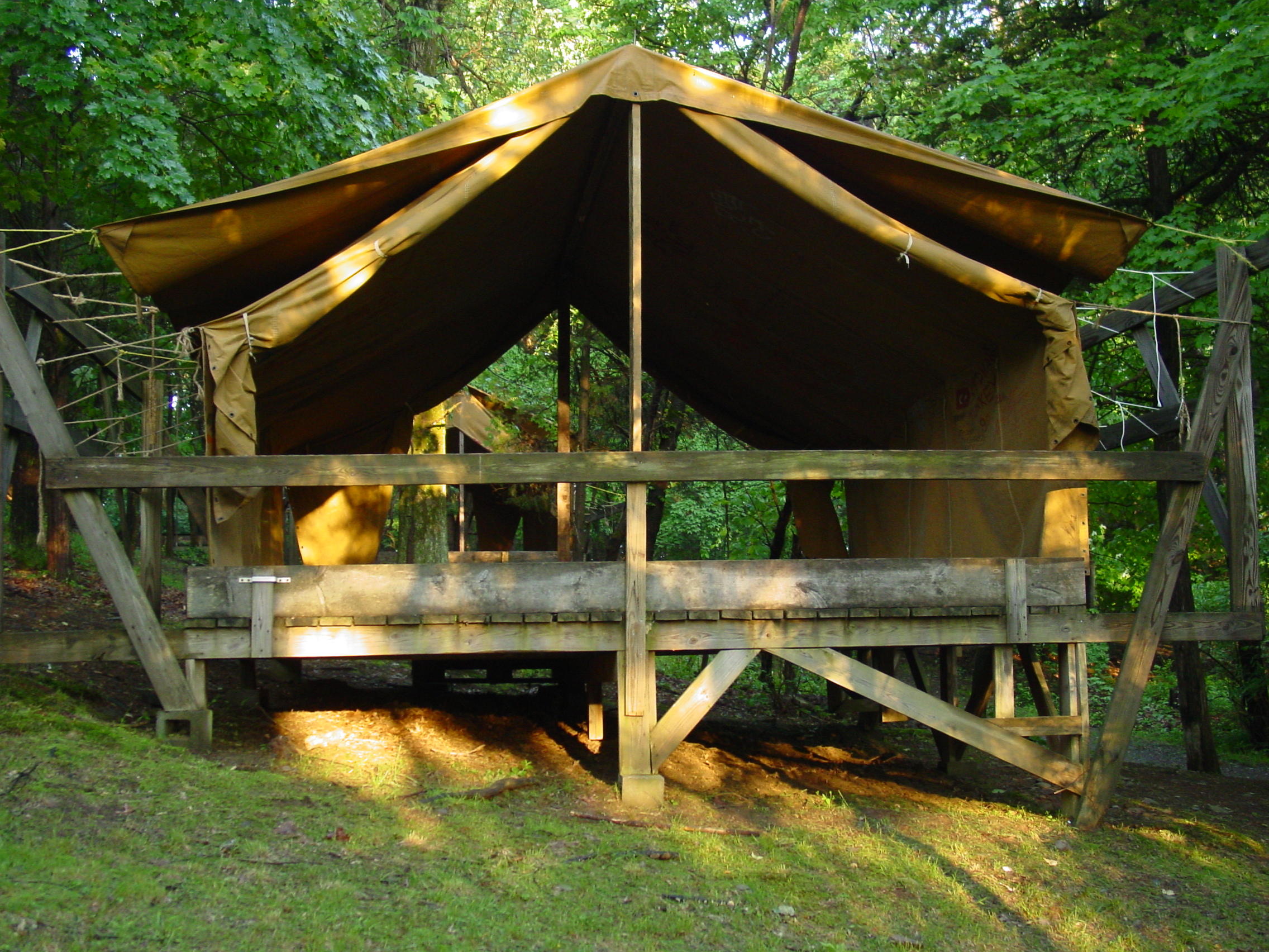  Campers sleep on cots in wooden-platform canvas tents like these. 