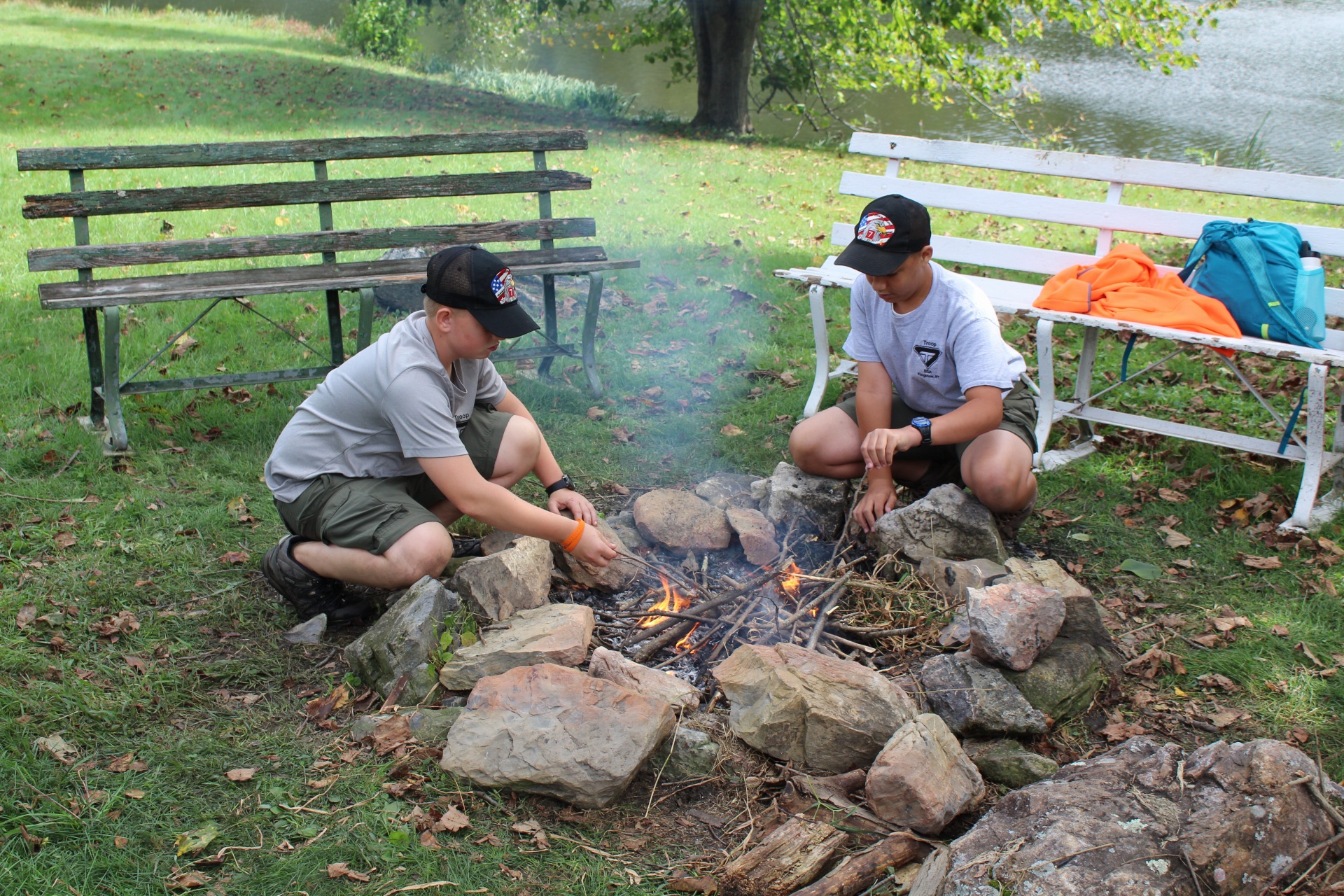  Two students build a fire 