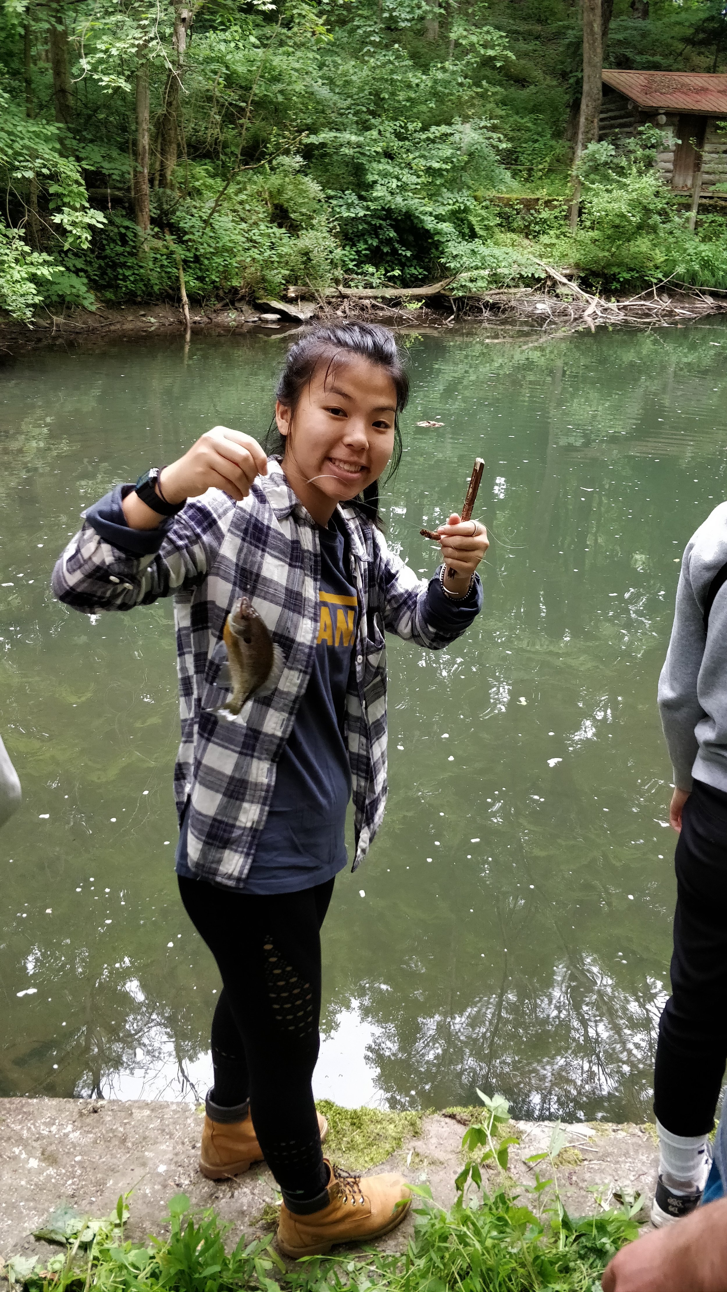  A camper catches a fish while on a wilderness trip at the Red Hook campus.  