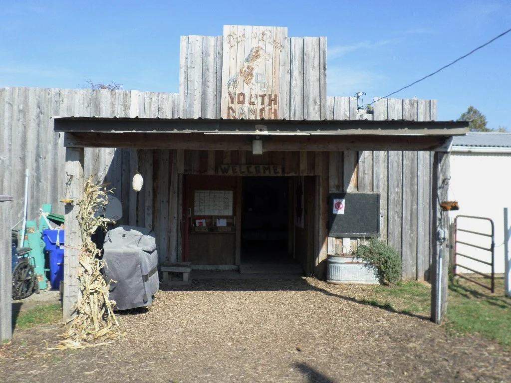 The entrance to the barn, with Dare to Dream Youth Ranch above the door.