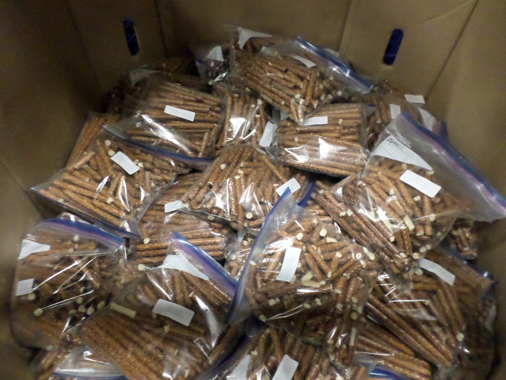 Volunteers have many jobs; one of them is repackaging bulk items the food bank receives from retailers, such as pretzels or popcorn, into smaller portions to be distributed to families.