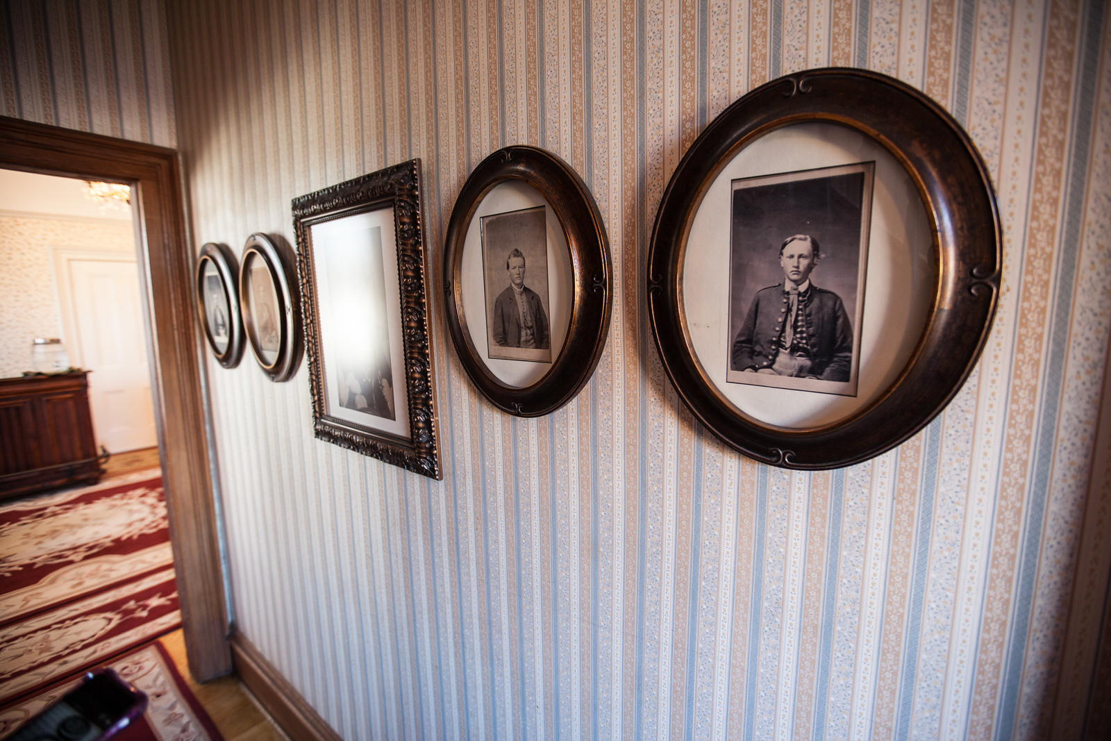 Walls lined with historic photographs (Sion Bass House)