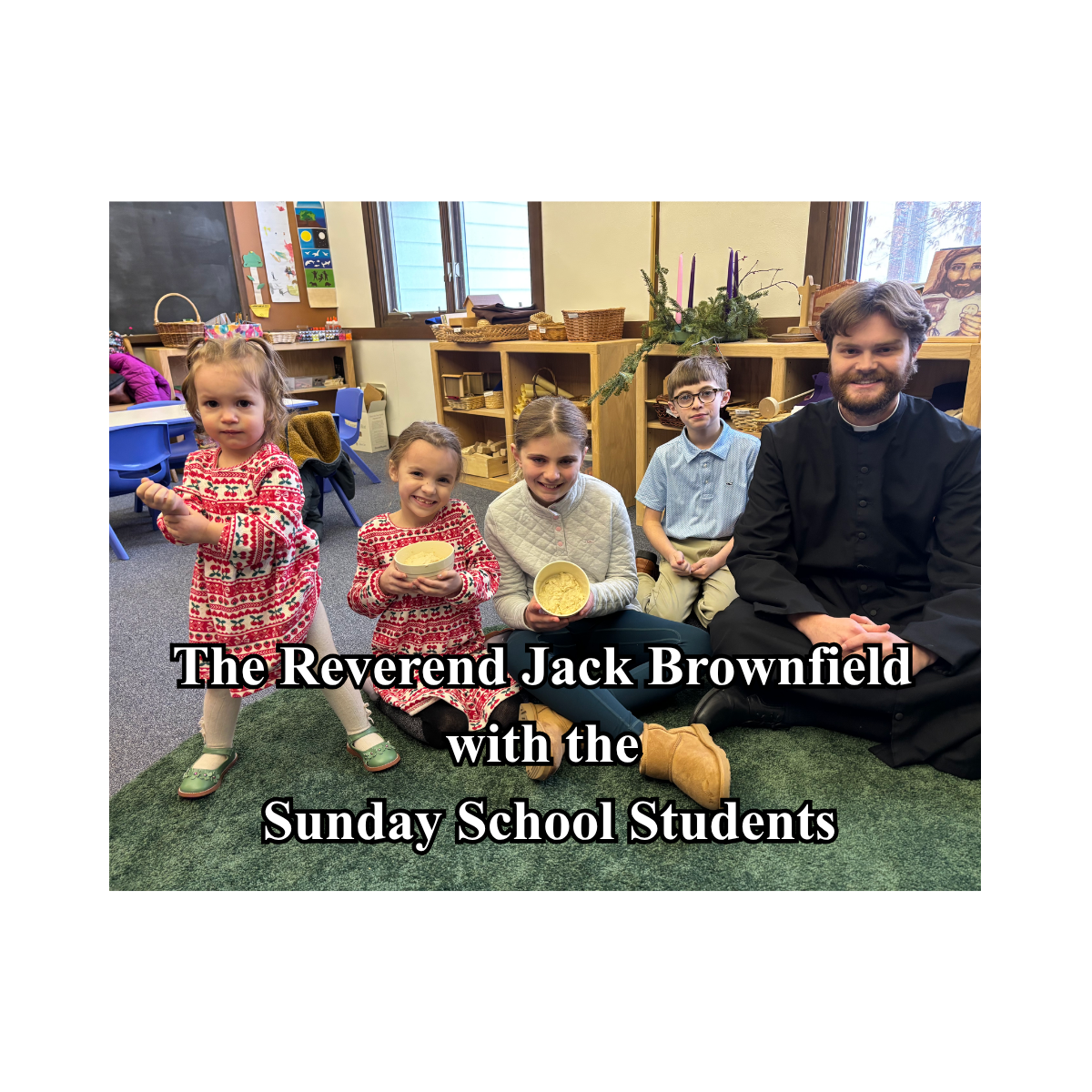 The Reverend Jack Brownfiels sitting with 4 children from St. Michael's of the Valley Sunday School Class