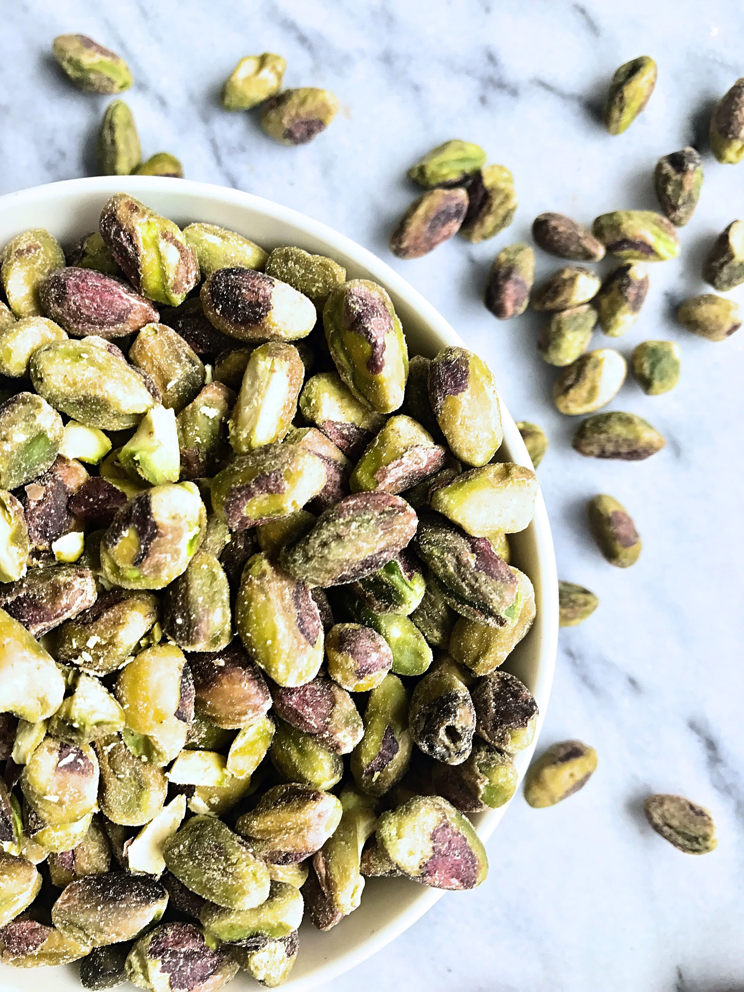 PISTACHIOS For those of you, who follow me on social media or have spent more than 5 minutes with me, know about my obsession with pistachios. Let's just say that my thumbs have more callus from opening the shells than my feet. Thankfully I can happily continue munching on them as they contain not only the highest amount of protein than all the other nuts, but they also have the fewest calories, are a good source of essential minerals, fiber and vitamin B6. 