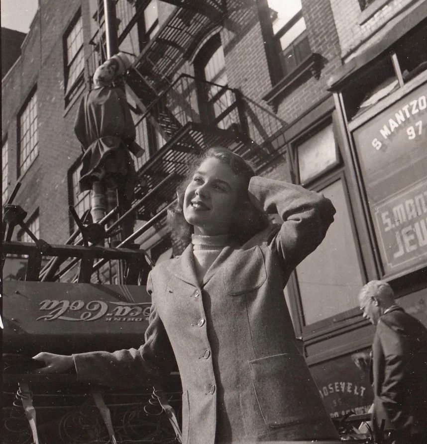 Betsy Clark, Cary Grant's future wife, on Chrystie Street on the Lower East Side; an effigy of Hitler hangs above her from a fire escape. 1943-44