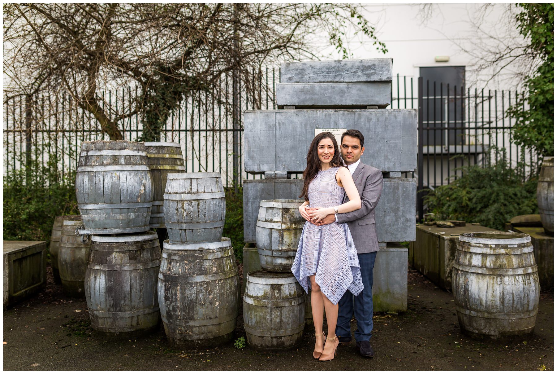 couple cuddling in front of barrels