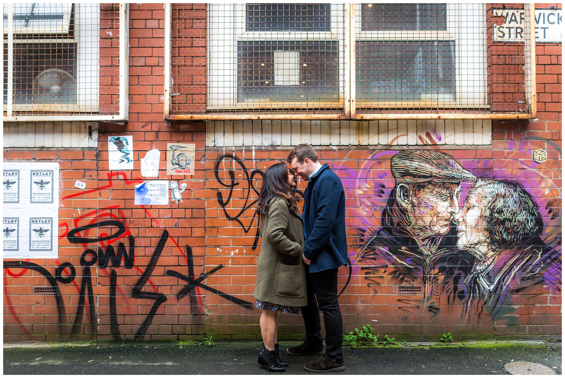 wide shot of couple with graffiti background