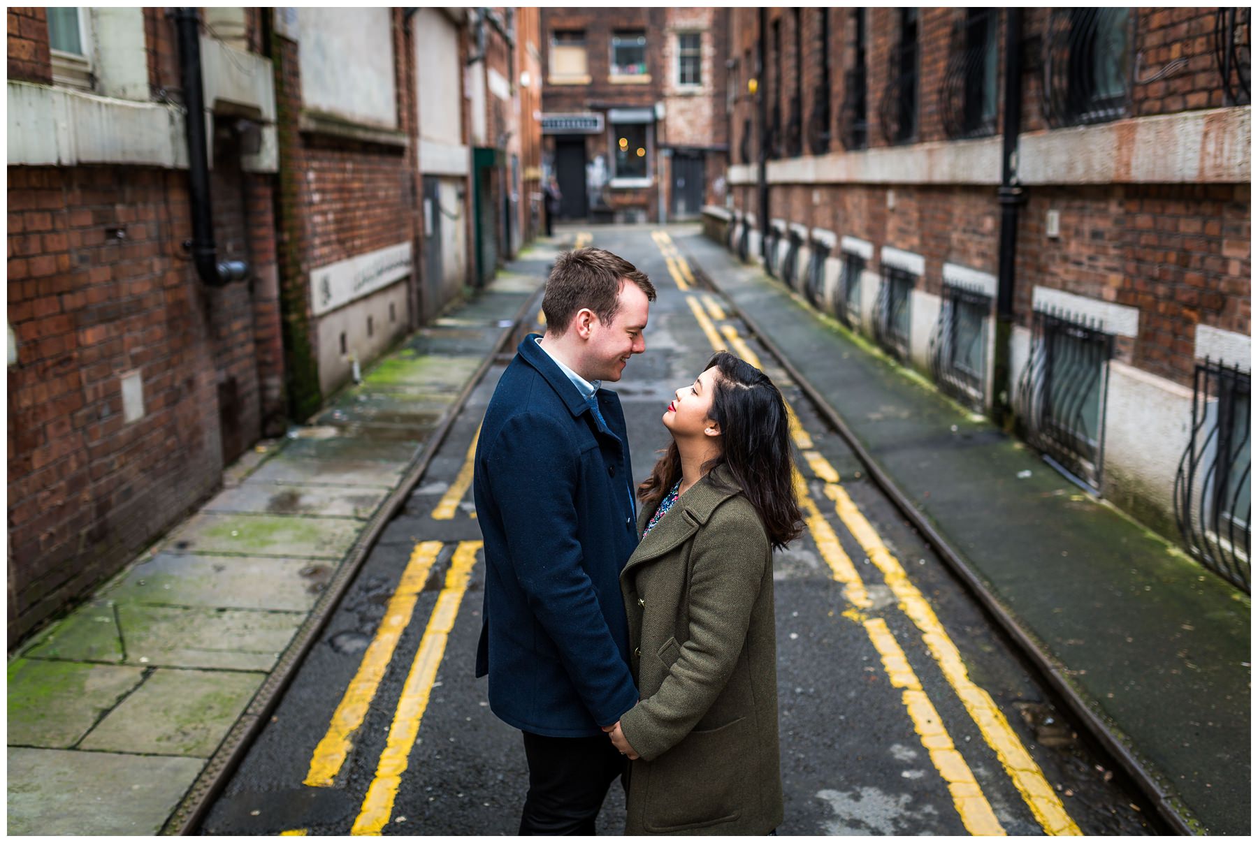 couple shot from above with city screen behind them