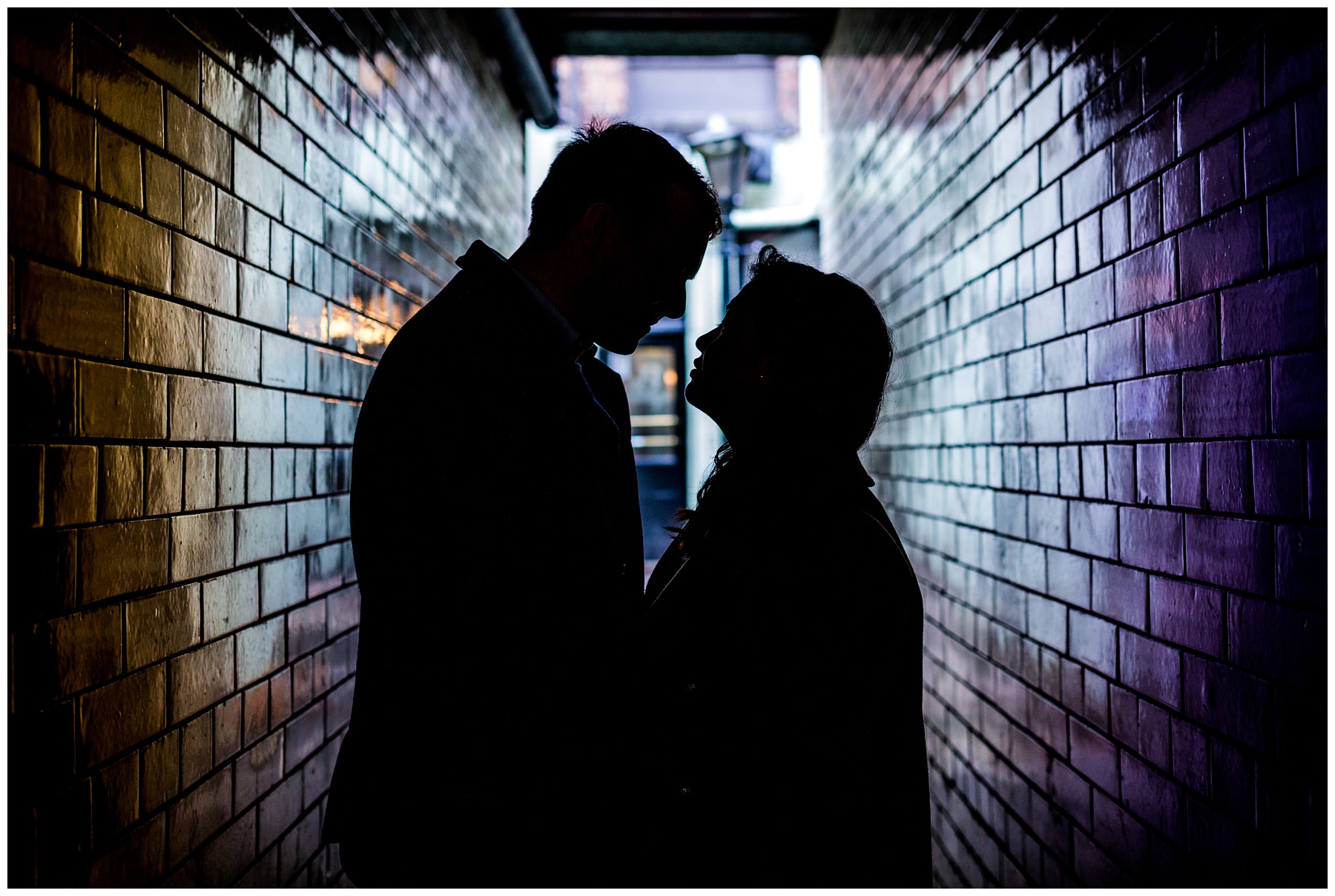 silhouette of couple down alley 