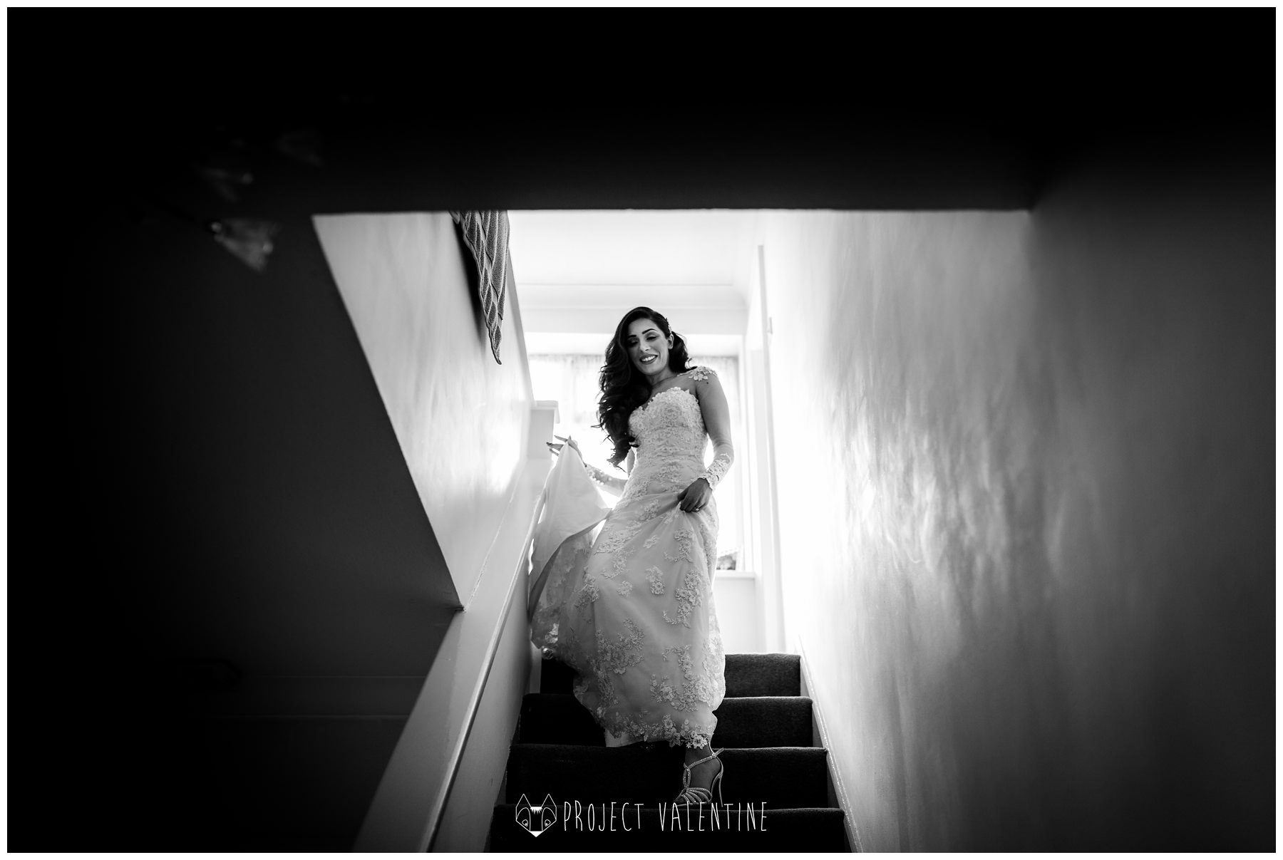 bride walking down the stairs in her wedding dress