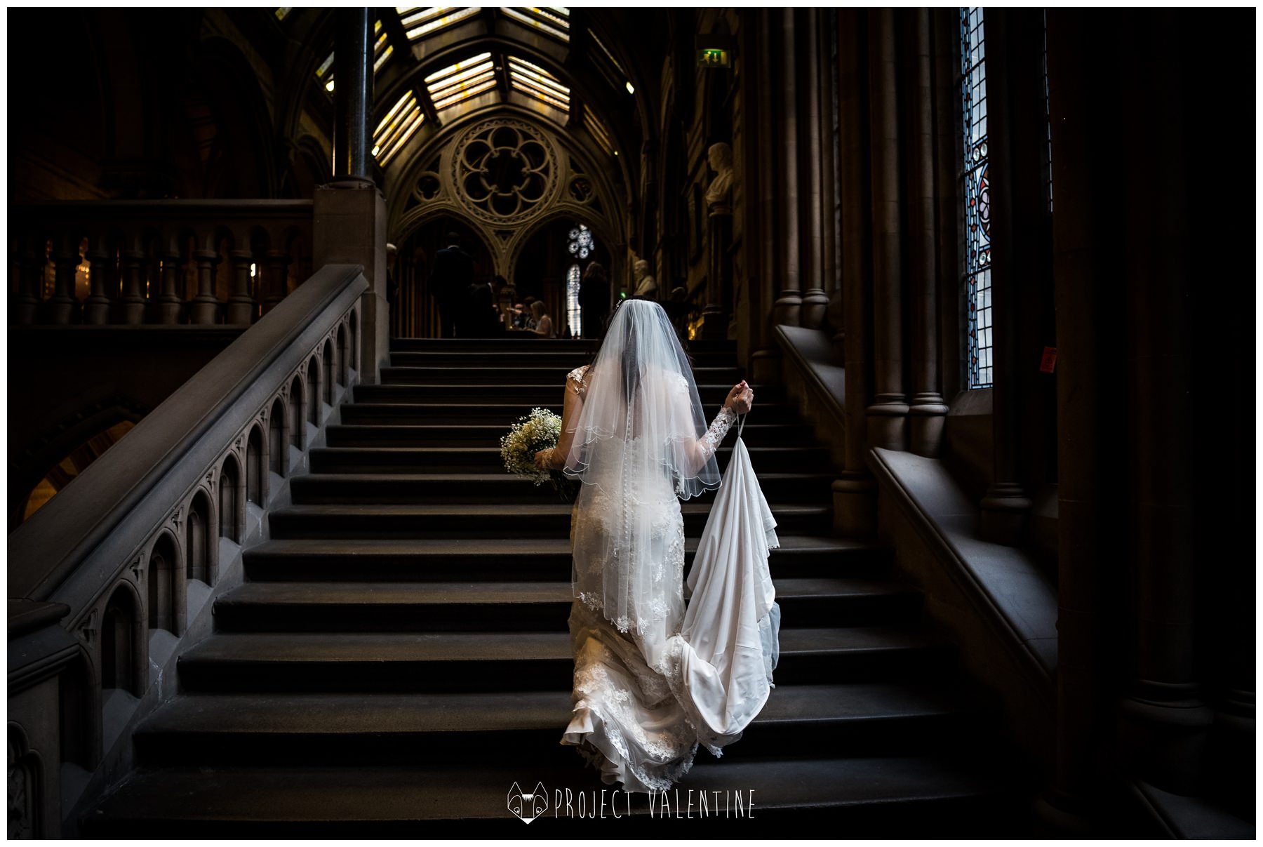 bride walking up the stairs in manchester town hall