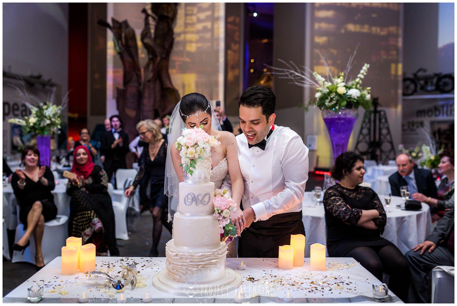 bride and groom cutting wedding cake