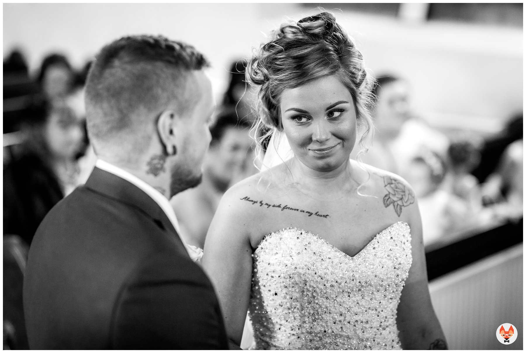 bride looking at groom during service