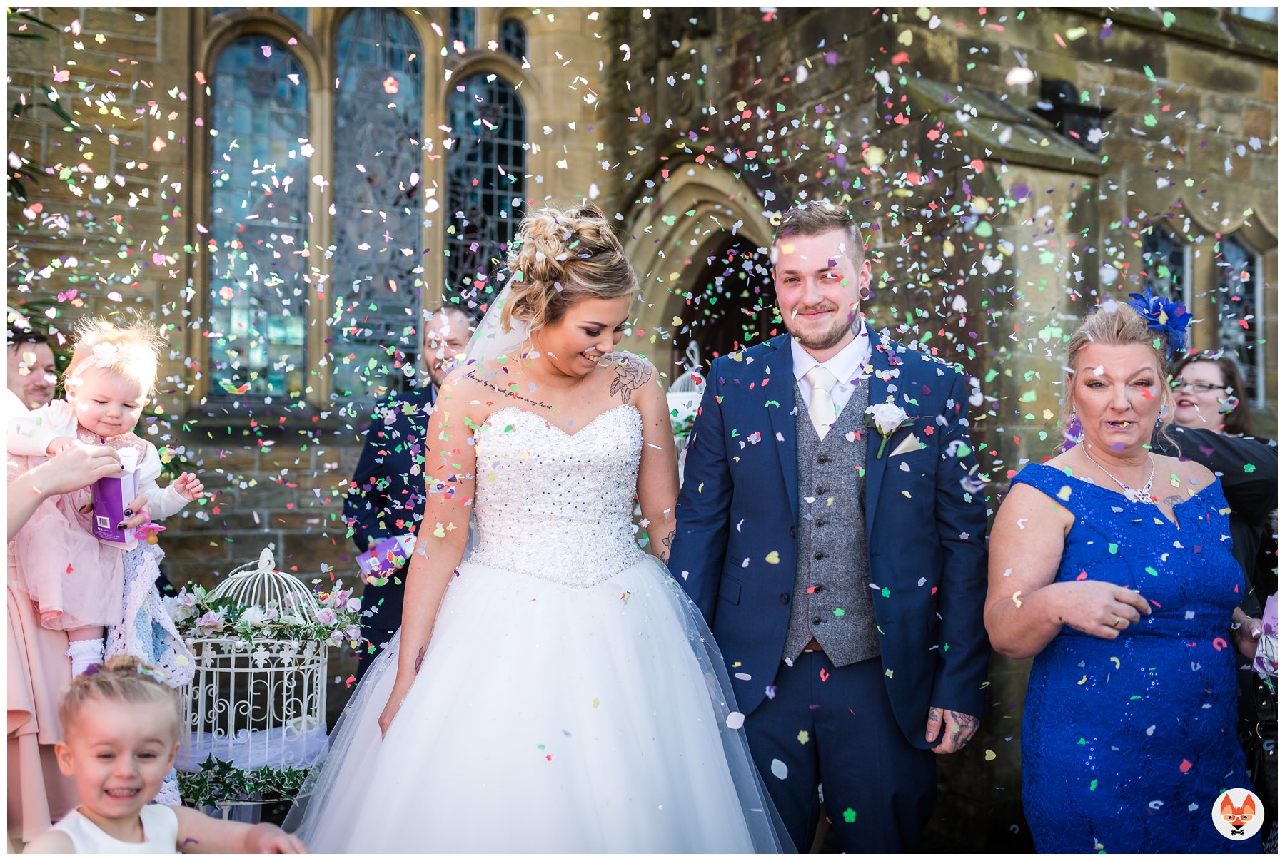 bride and groom showered in confetti