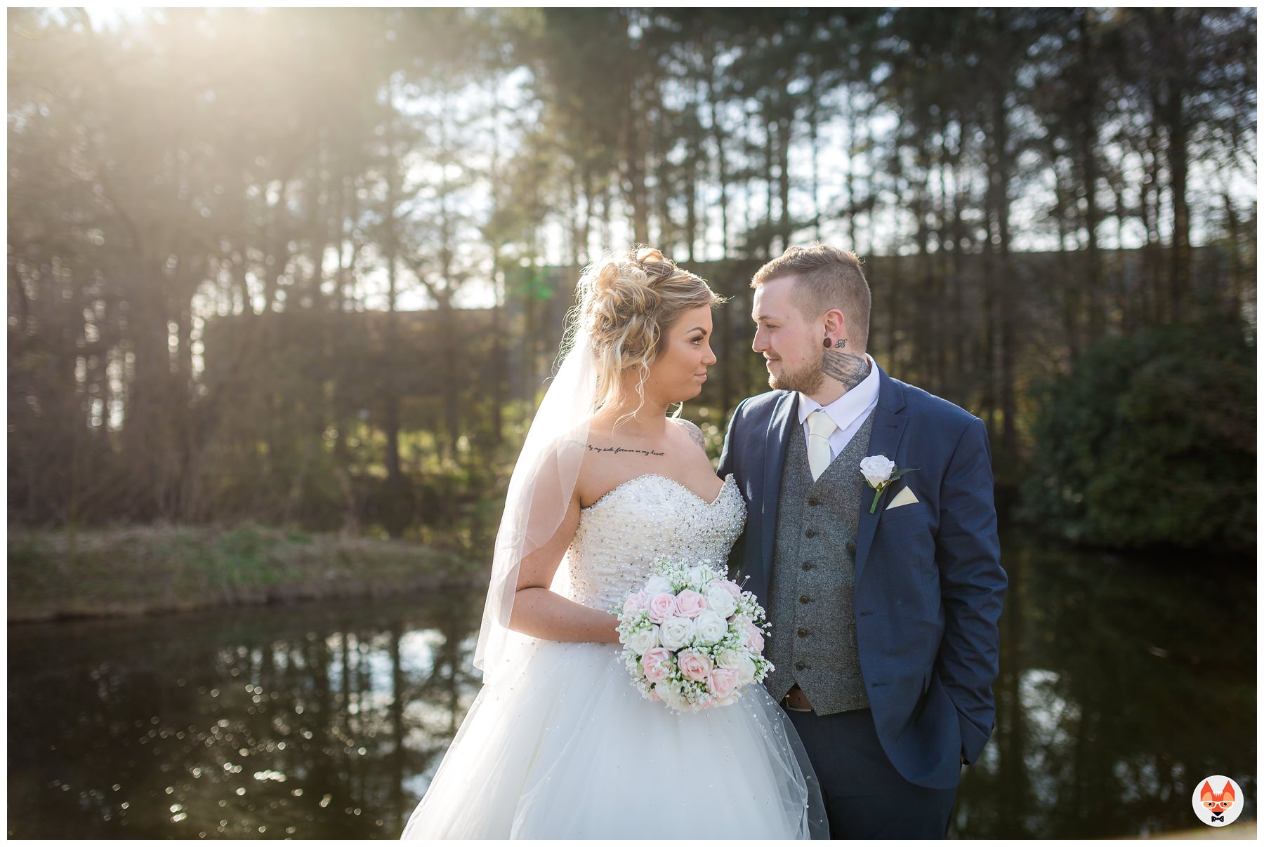 bride and groom by lake