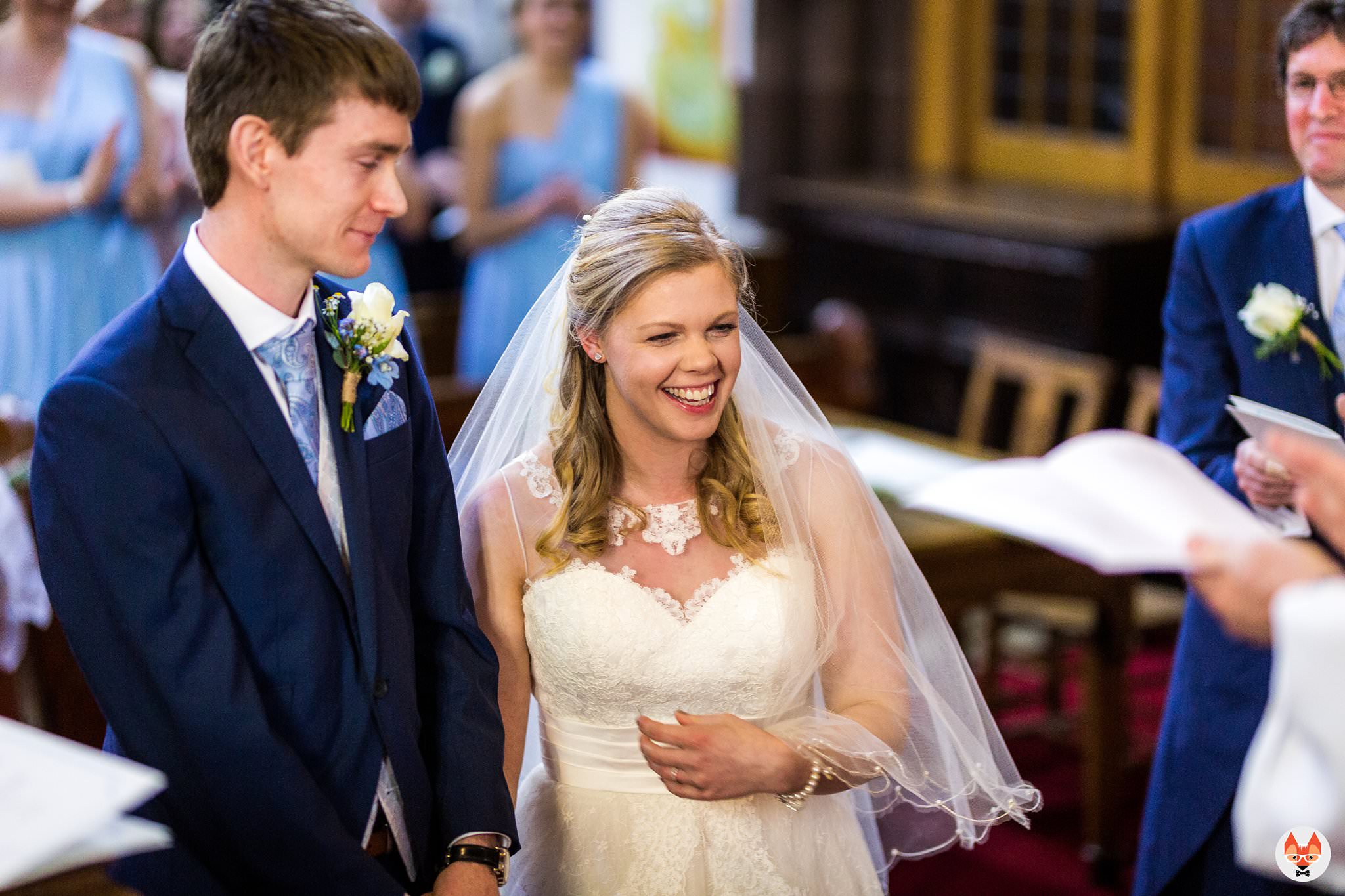 bride and groom laughing during service