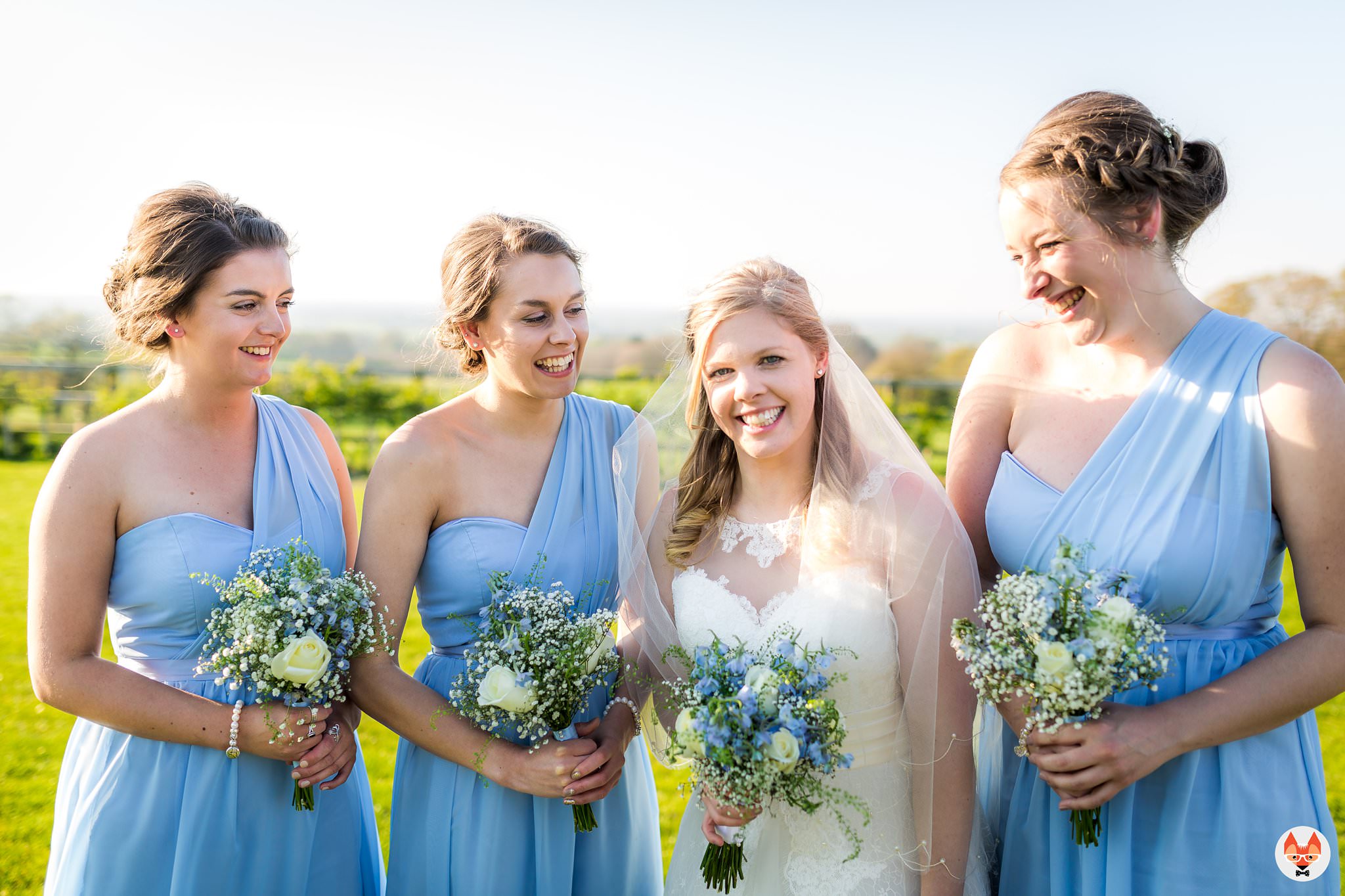 bride laughing with bridesmaids